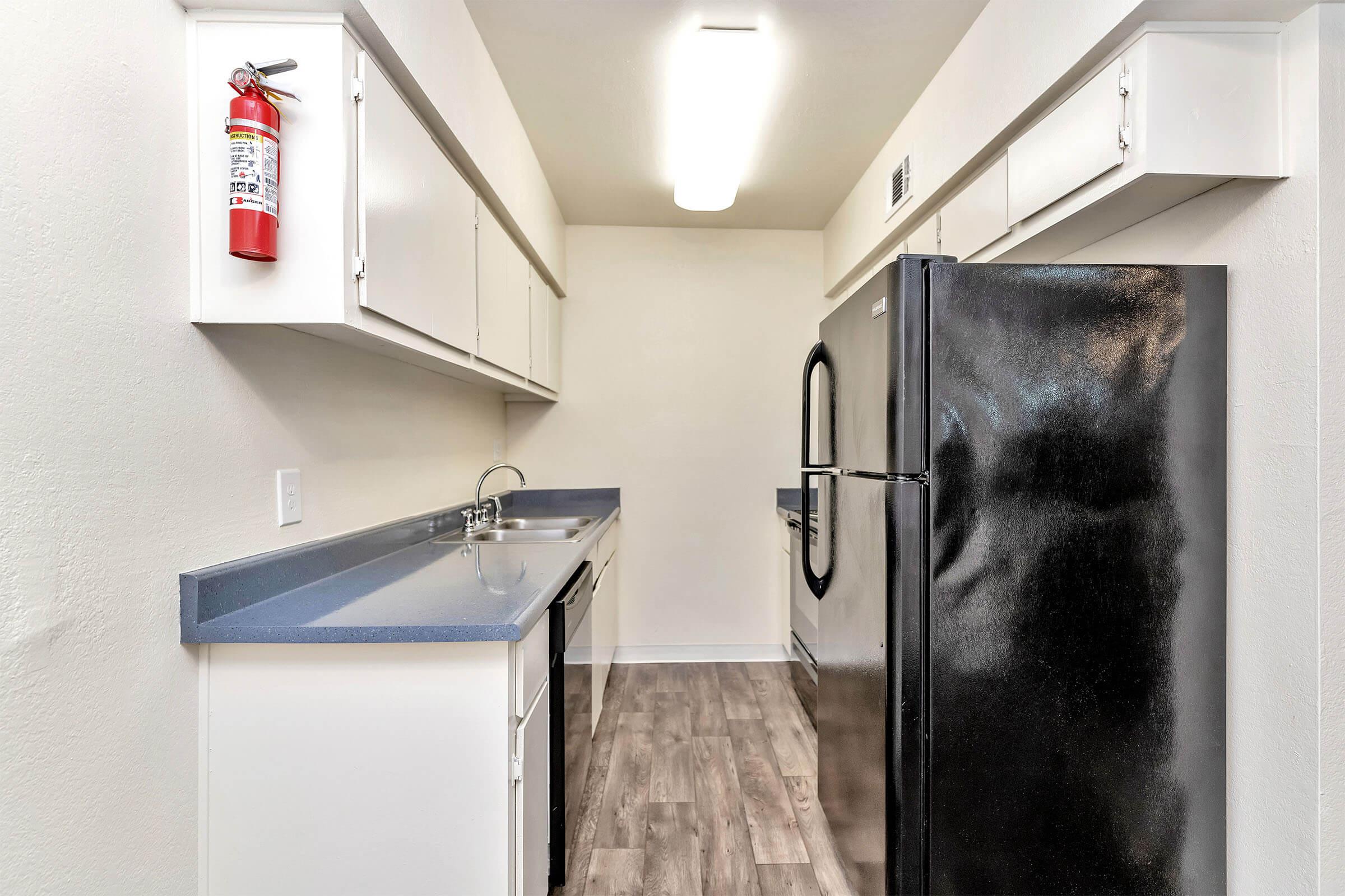 a kitchen with a sink and a refrigerator