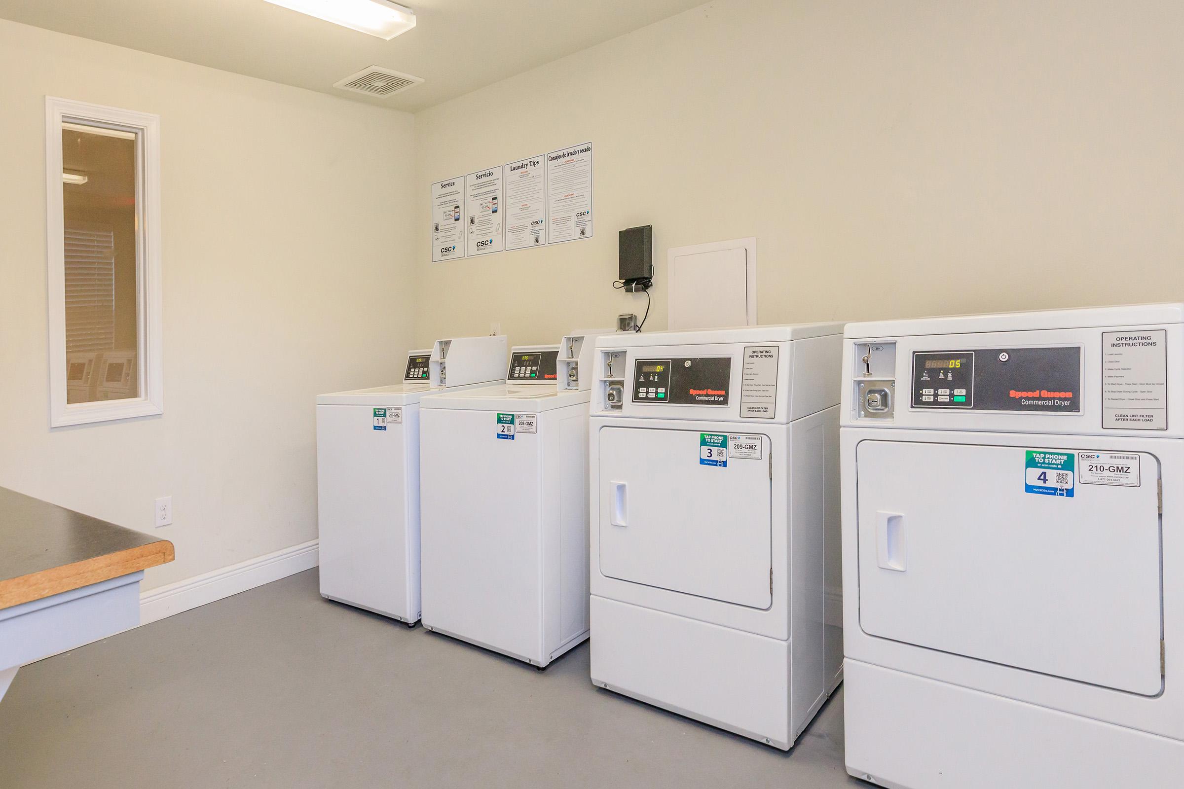 a kitchen with a white refrigerator freezer sitting in a room