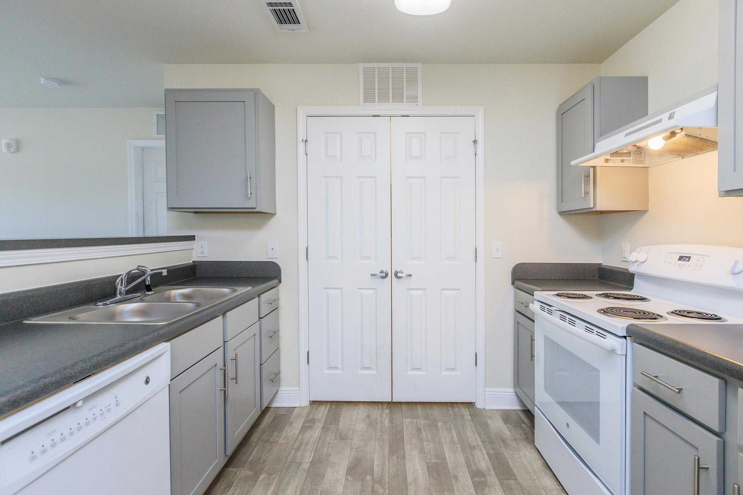 a kitchen with a stove a sink and a microwave