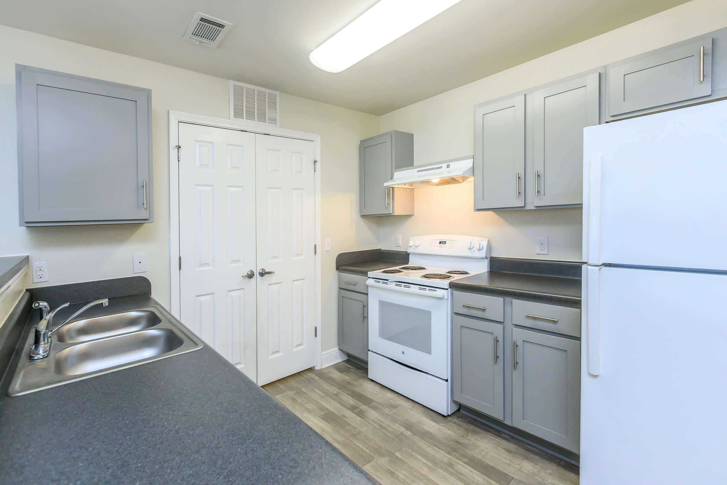 a kitchen with a stove sink and refrigerator