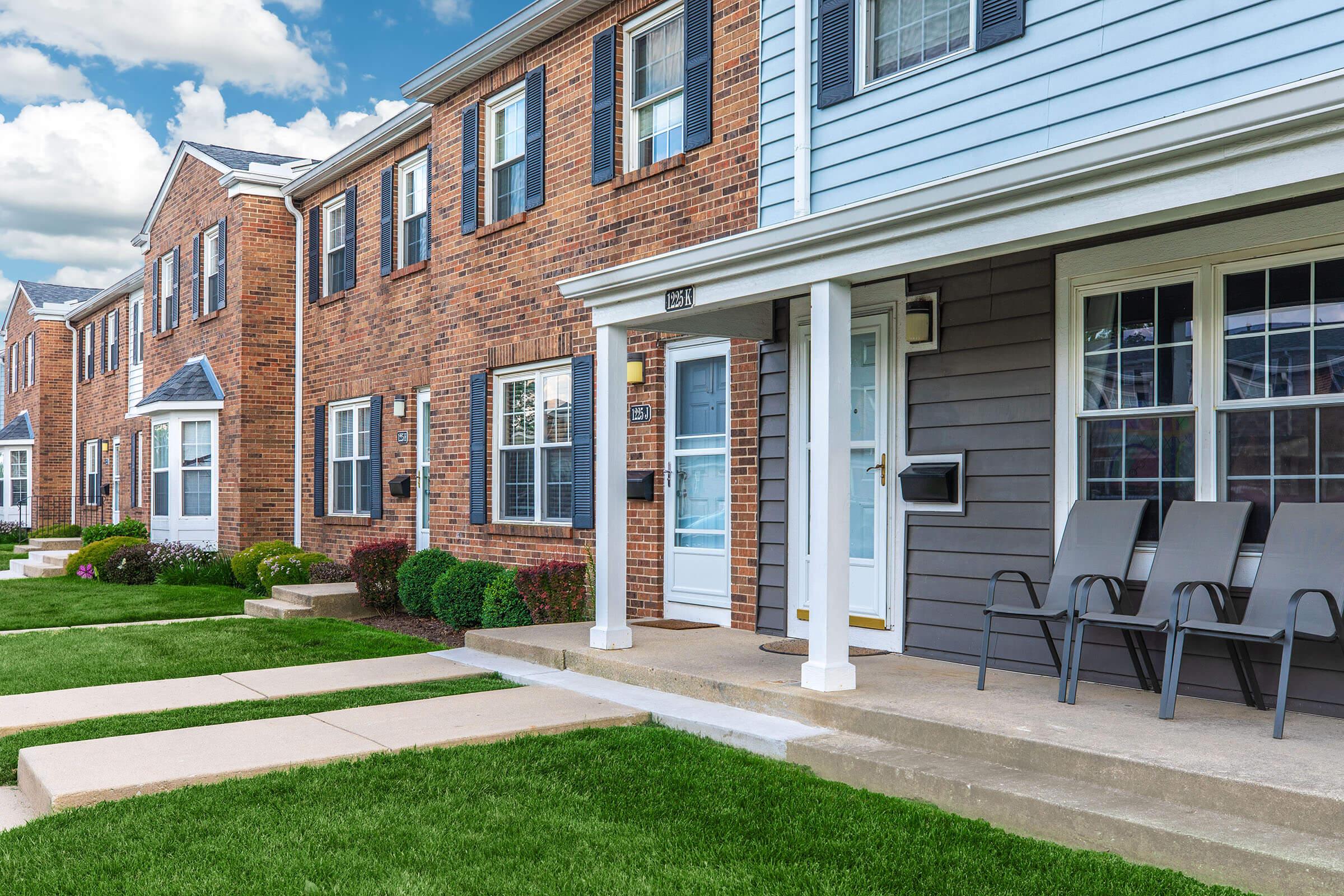 a large lawn in front of a brick building