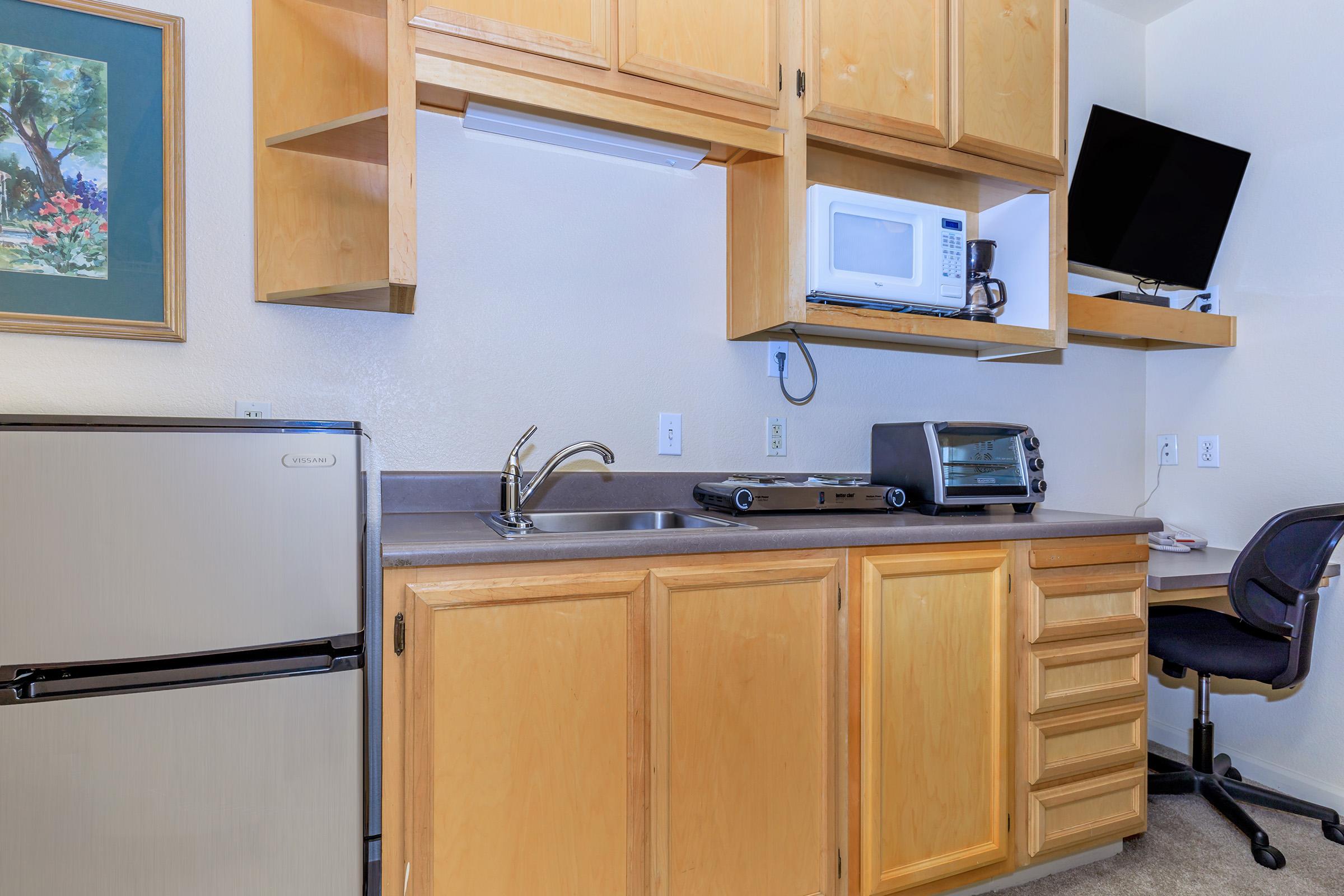 a kitchen with a stove top oven sitting inside of a room