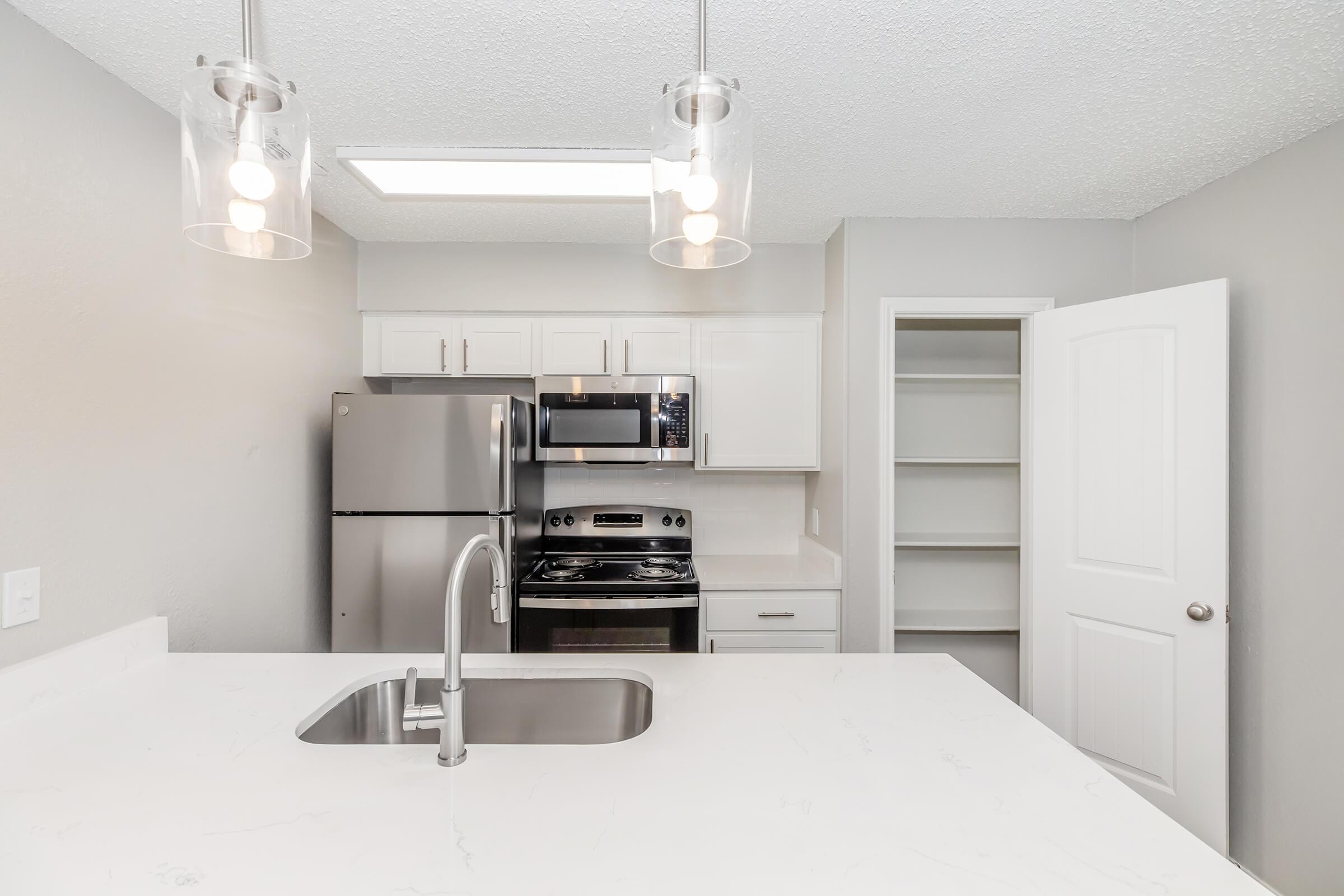 a kitchen with a sink and a mirror