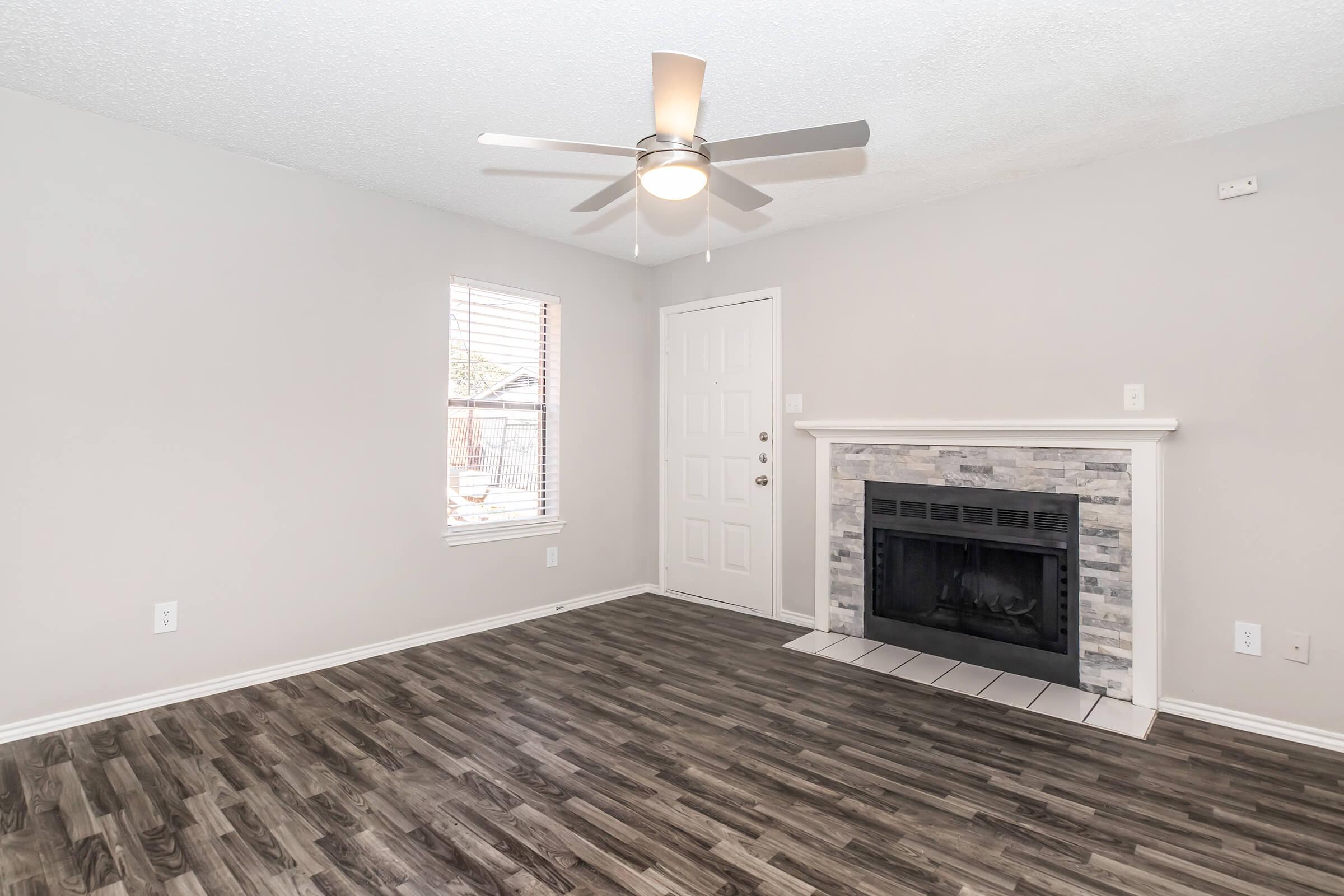 a living room filled with furniture and a fireplace