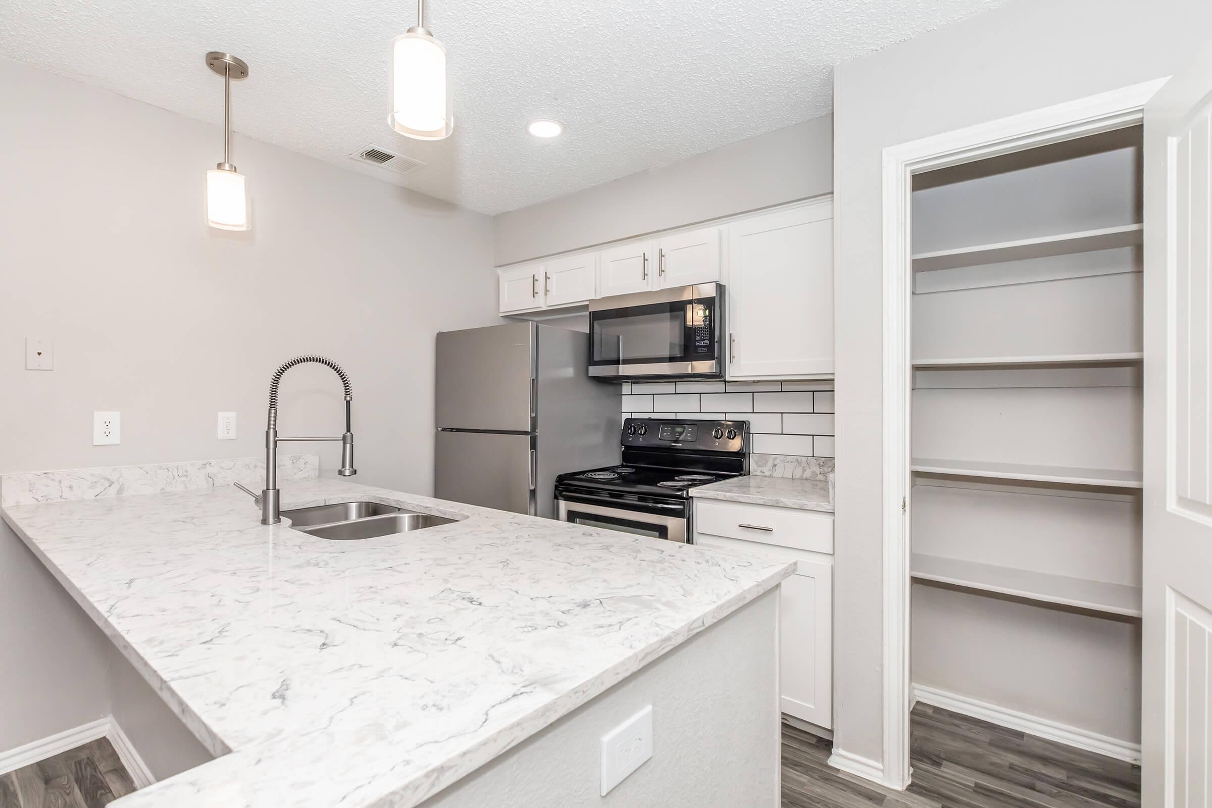 a kitchen with a stove and a sink