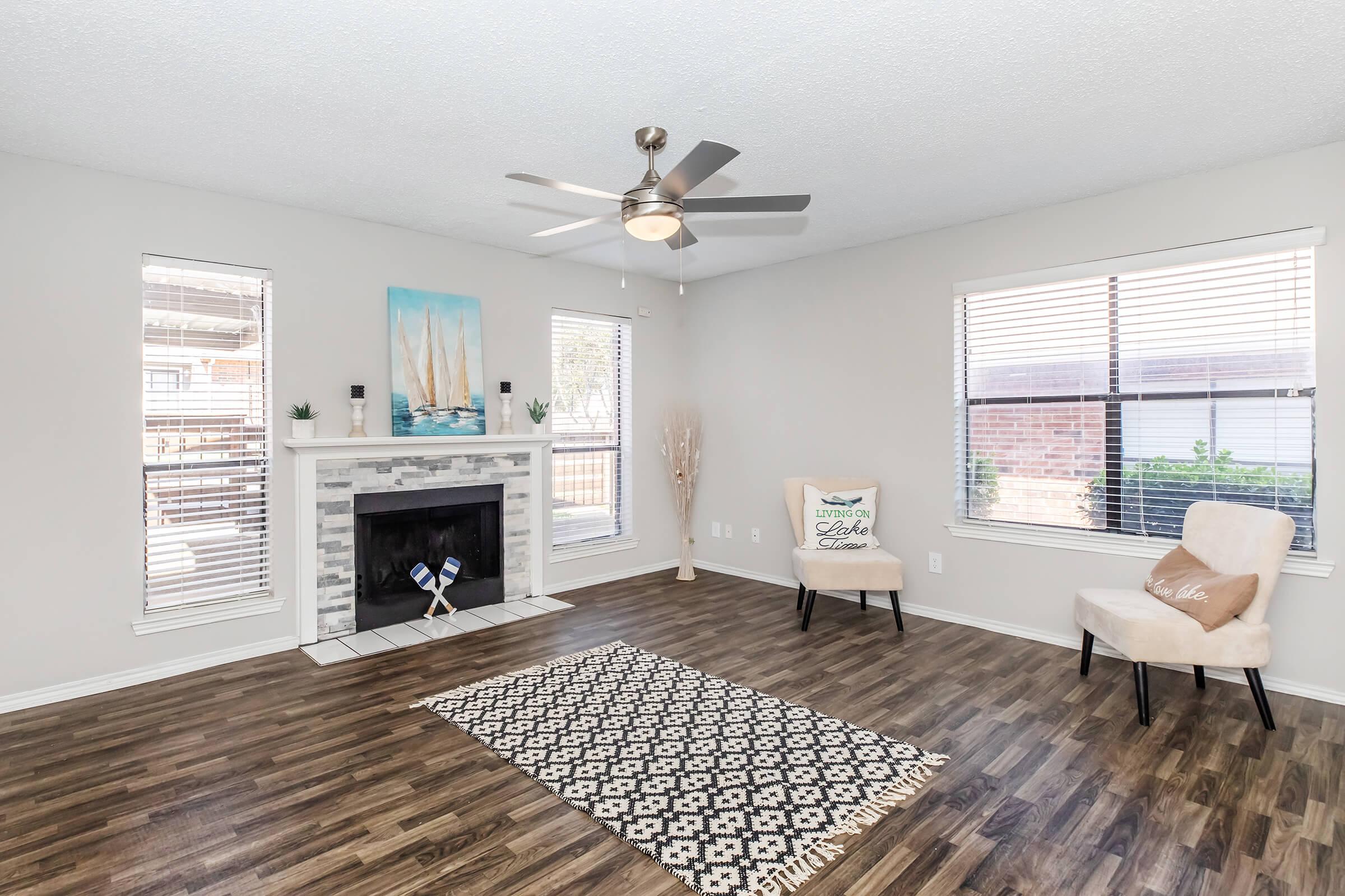 a living room filled with furniture and a large window