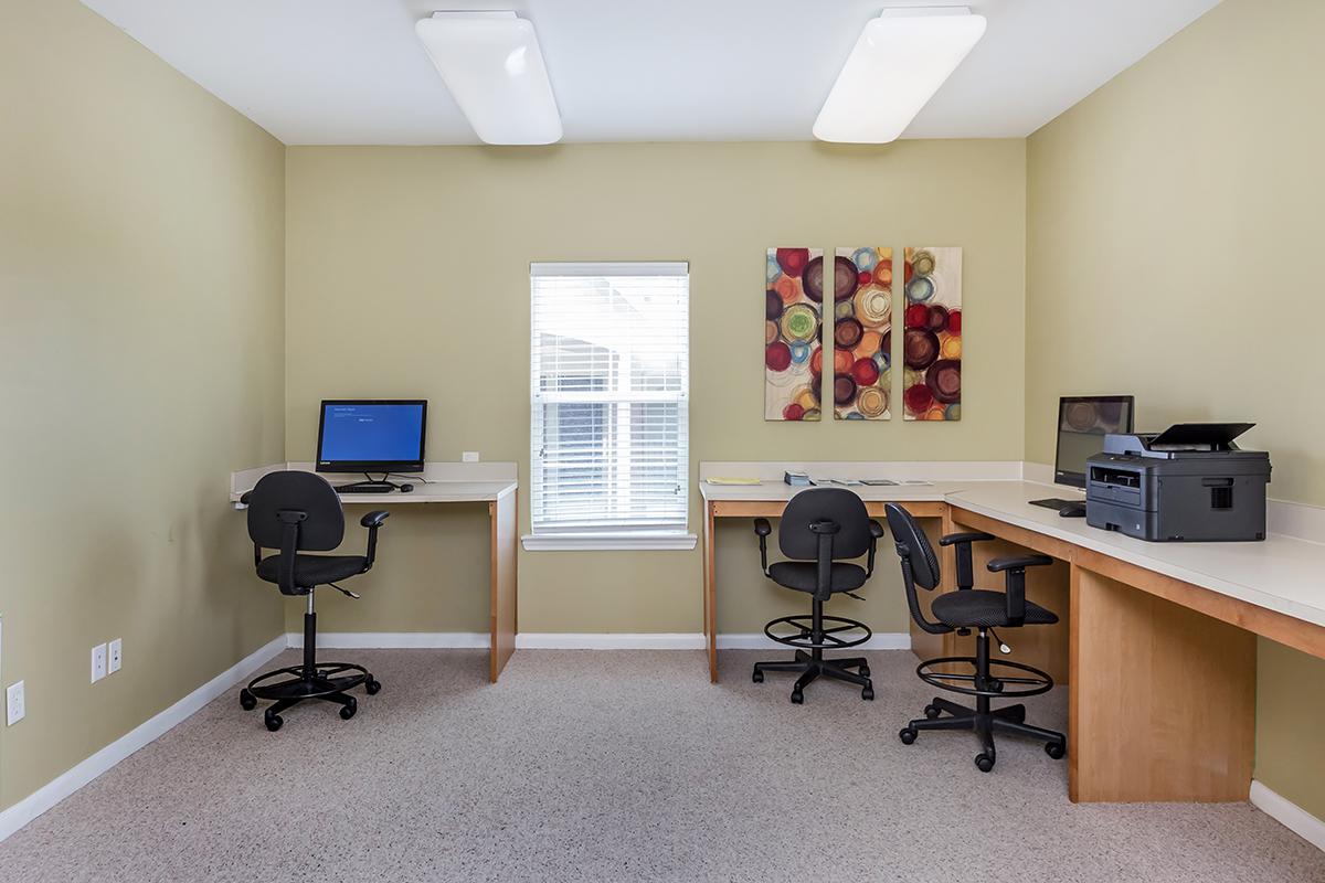 a bedroom with a desk and chair in a room