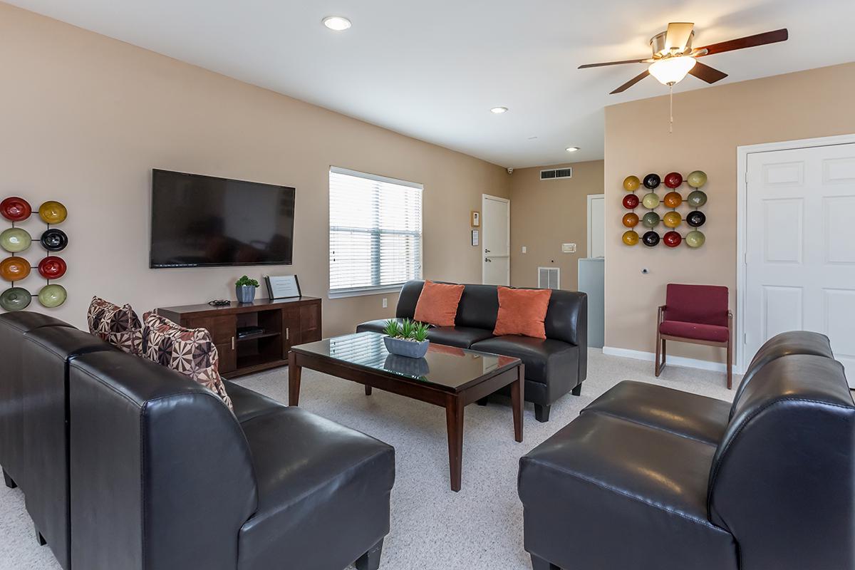 a living room filled with furniture and a flat screen tv