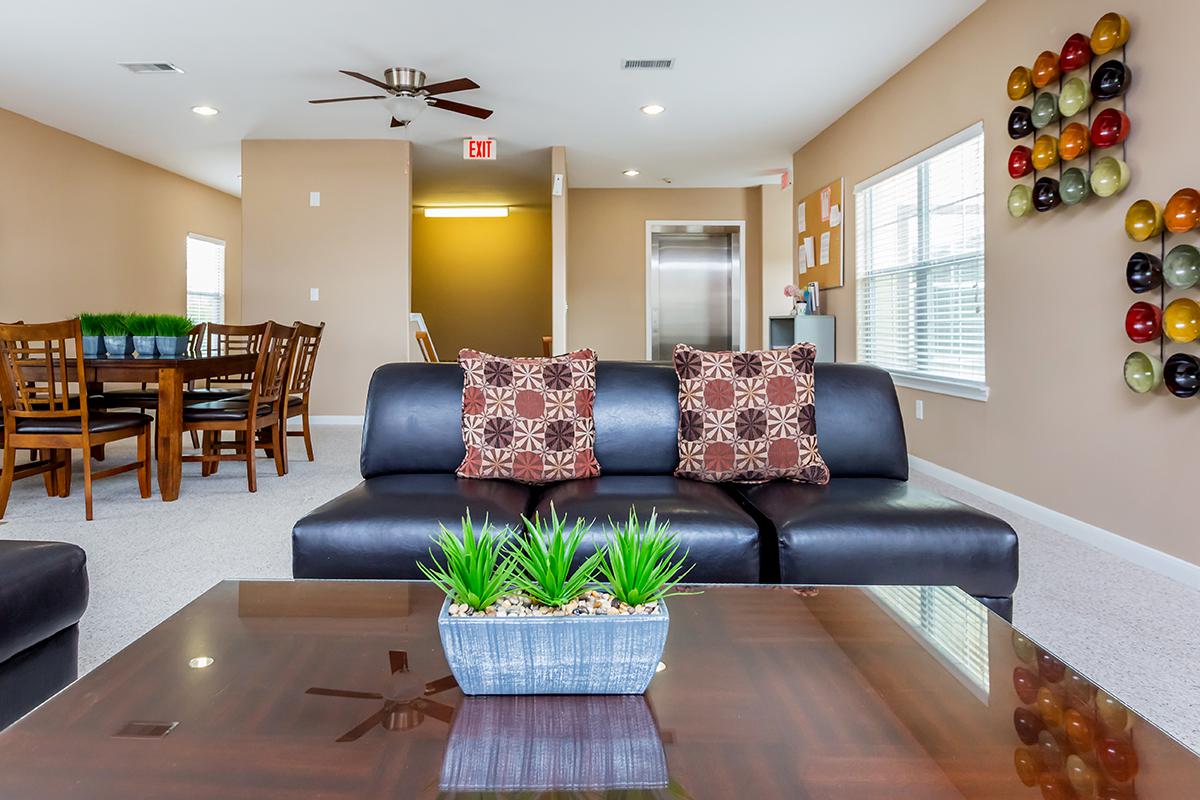 a living room filled with furniture and a table