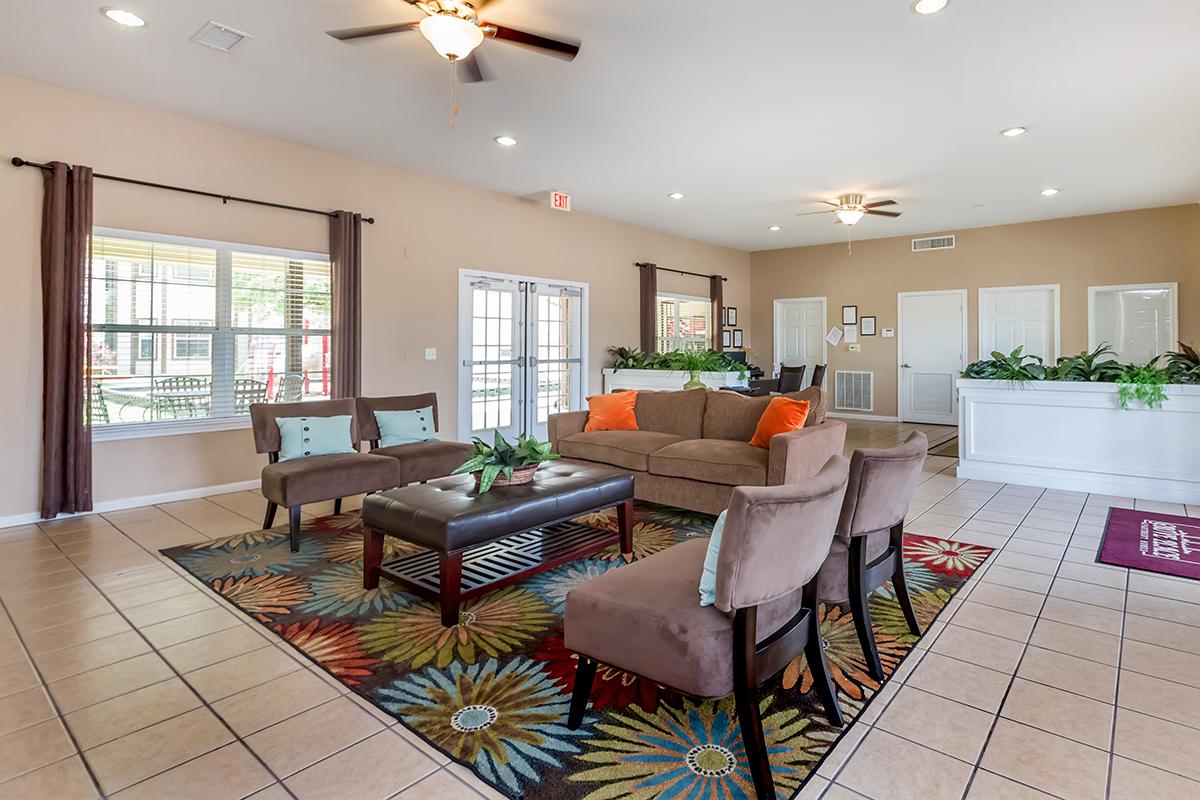 a living room filled with furniture and a large window