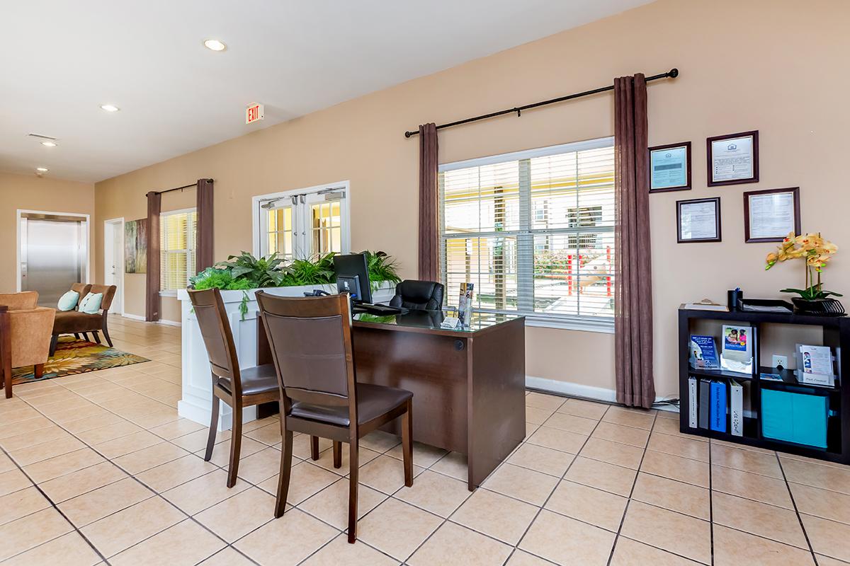 a living room filled with furniture and a large window