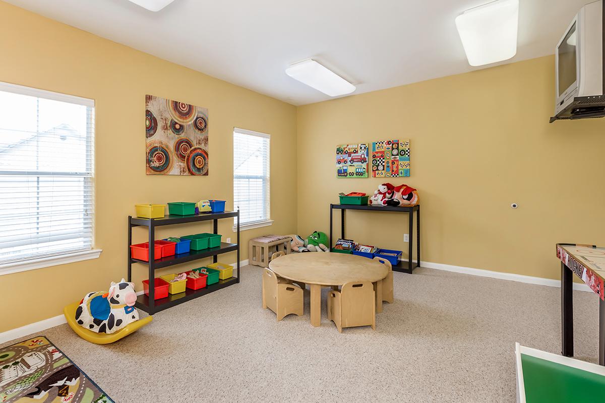 a living room filled with furniture and a tv