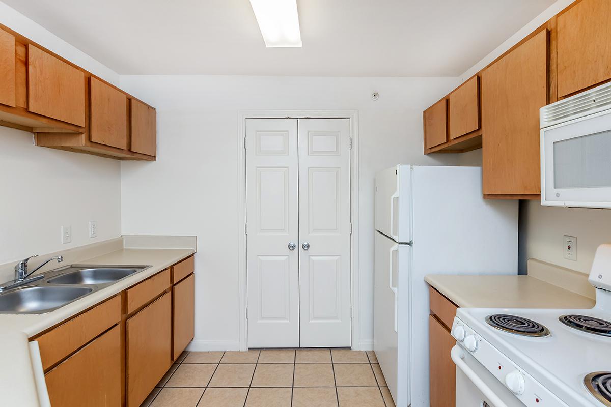 a kitchen with a stove sink and refrigerator