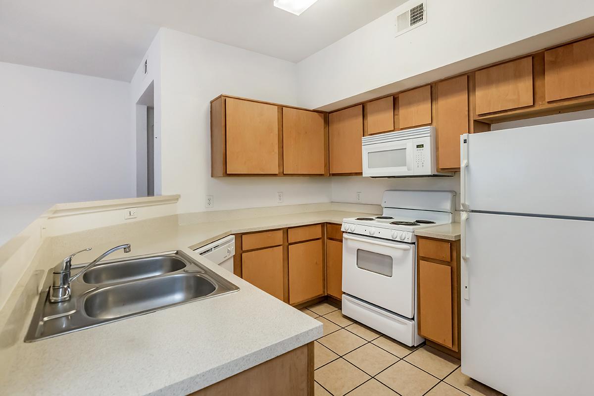 a kitchen with a stove sink and refrigerator