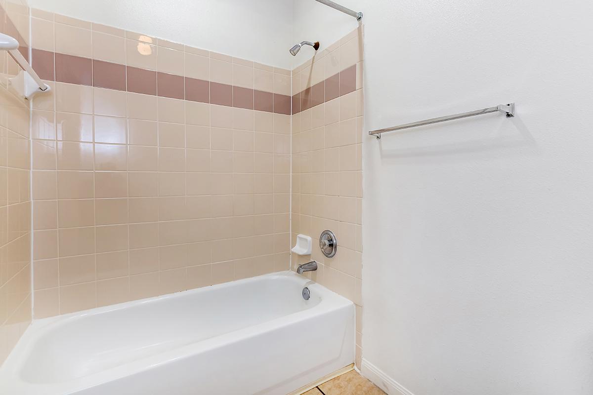 a white tub sitting next to a sink