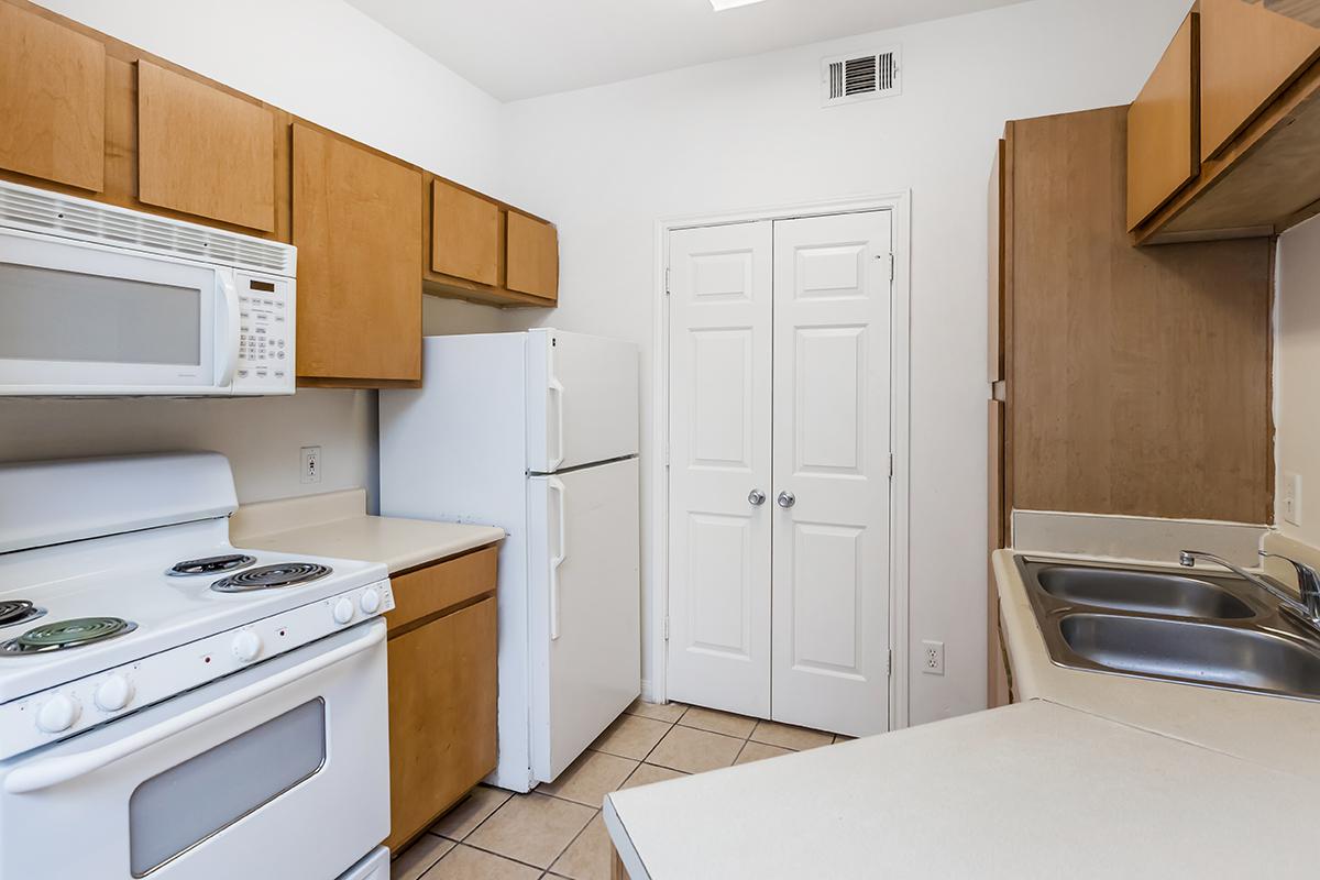 a white stove top oven sitting inside of a kitchen