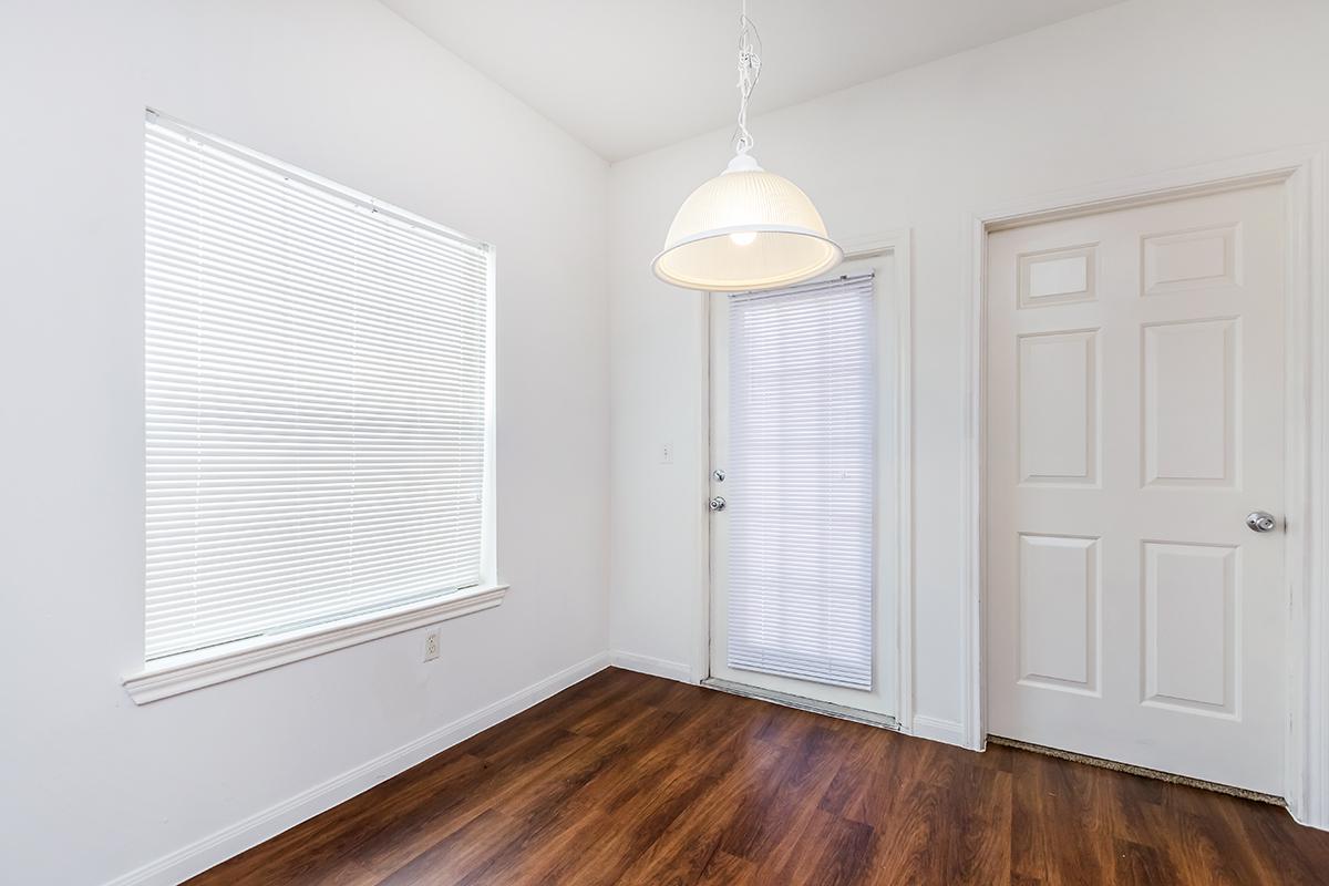 a close up of a hard wood floor next to a window