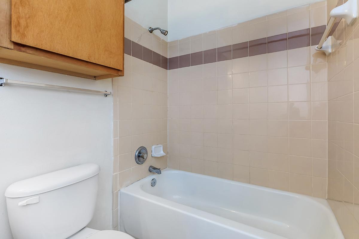 a white tub sitting next to a sink