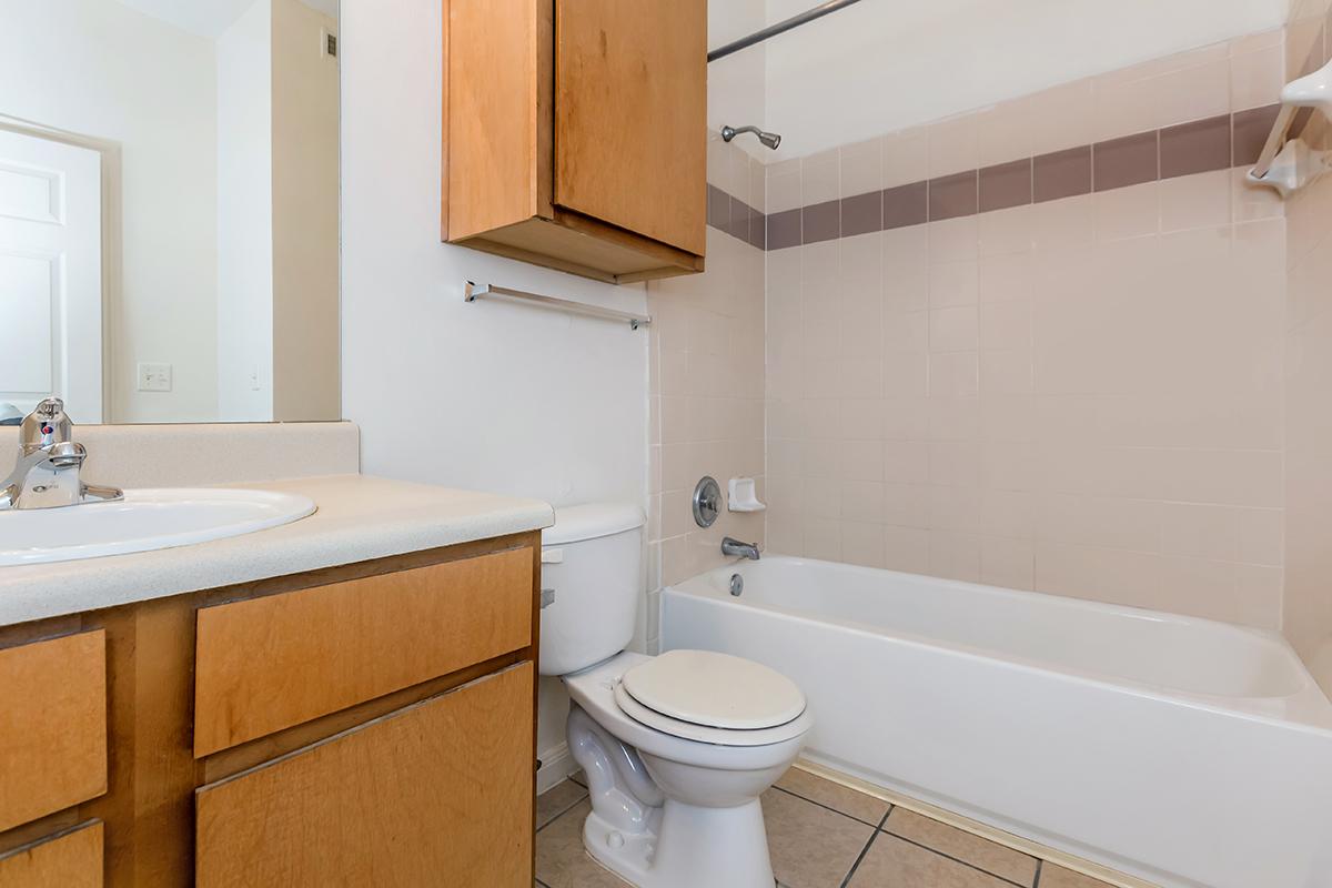 a white tub sitting next to a sink