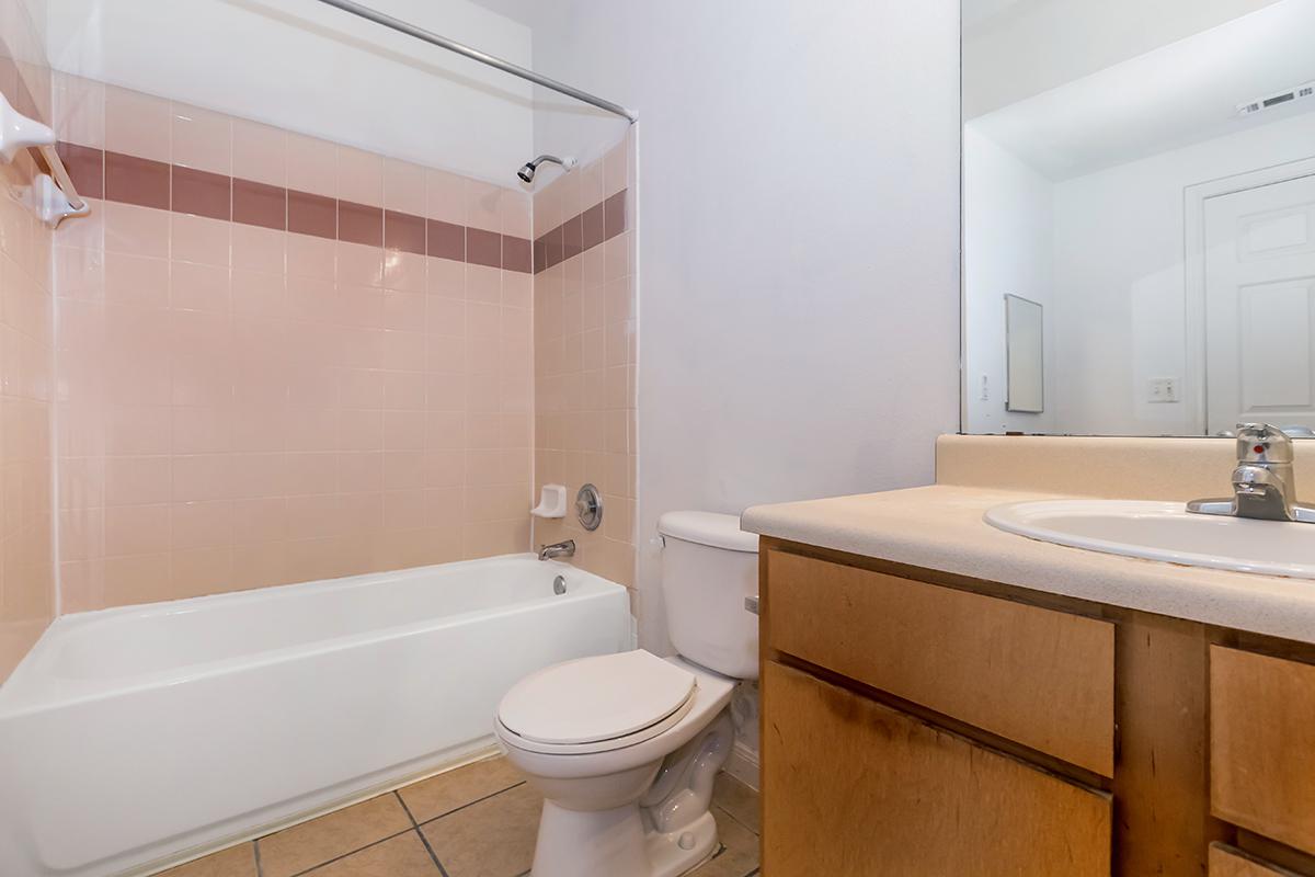 a white tub sitting next to a shower