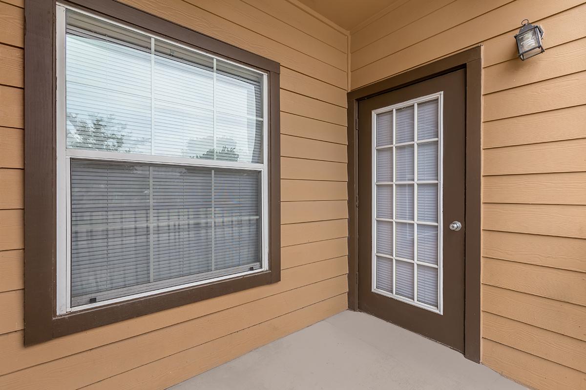 a door with a window in a brick building