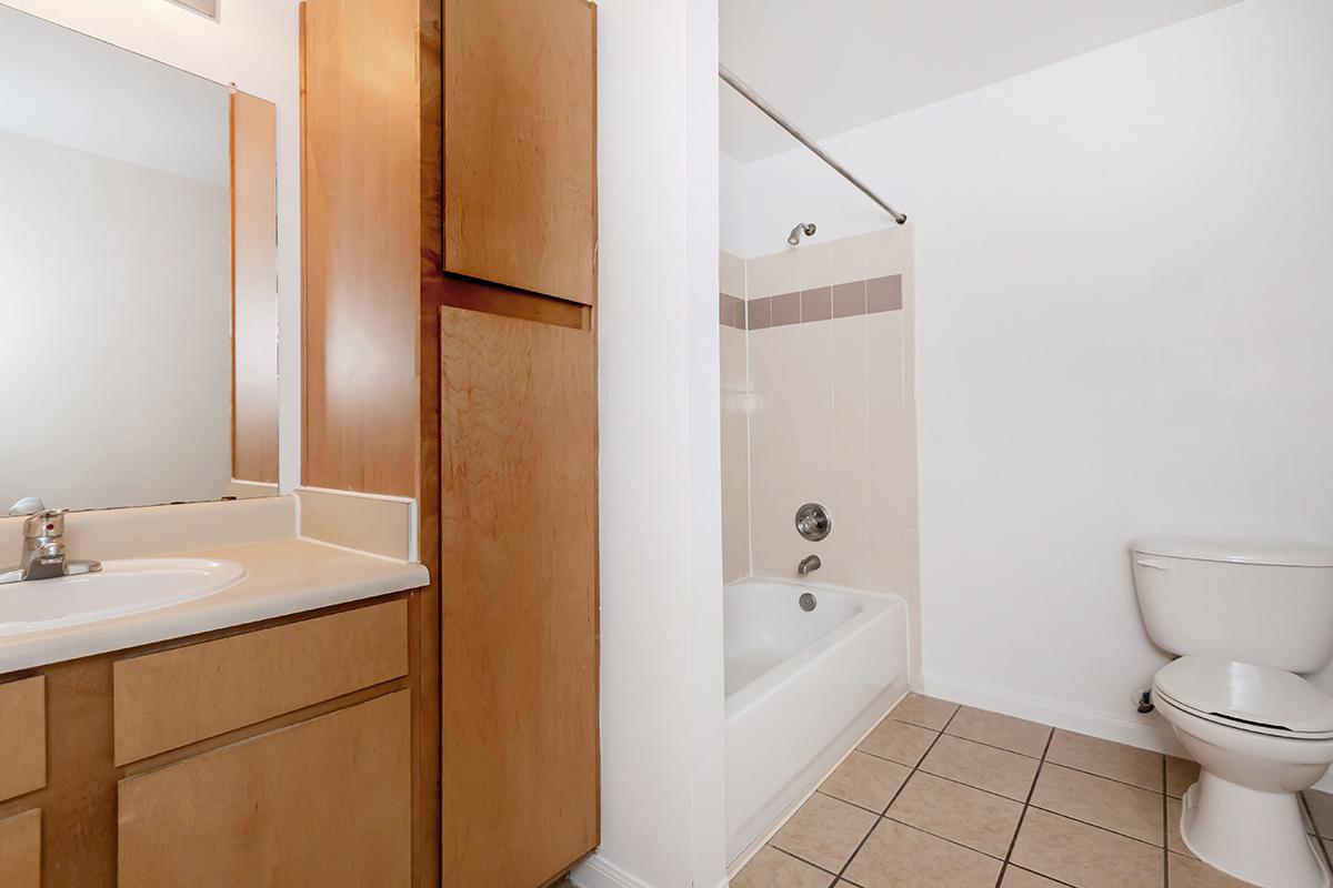 a white tub sitting next to a sink