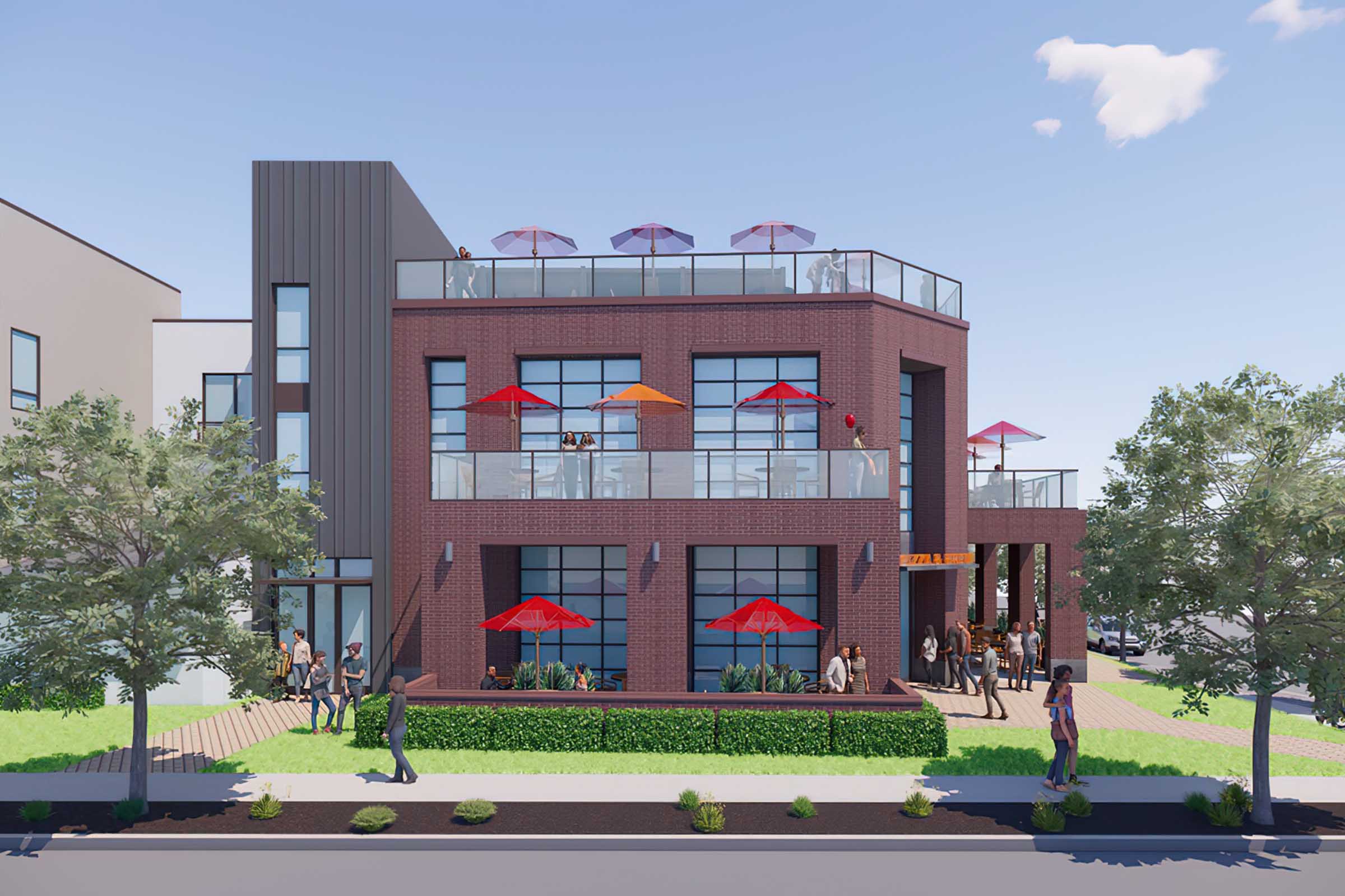A modern two-story building featuring large windows and a rooftop terrace with umbrellas. The ground level has outdoor seating under red umbrellas, with people enjoying the space. Surrounding landscaping includes greenery, and pedestrians stroll along the sidewalk. The sky is clear with a few clouds.