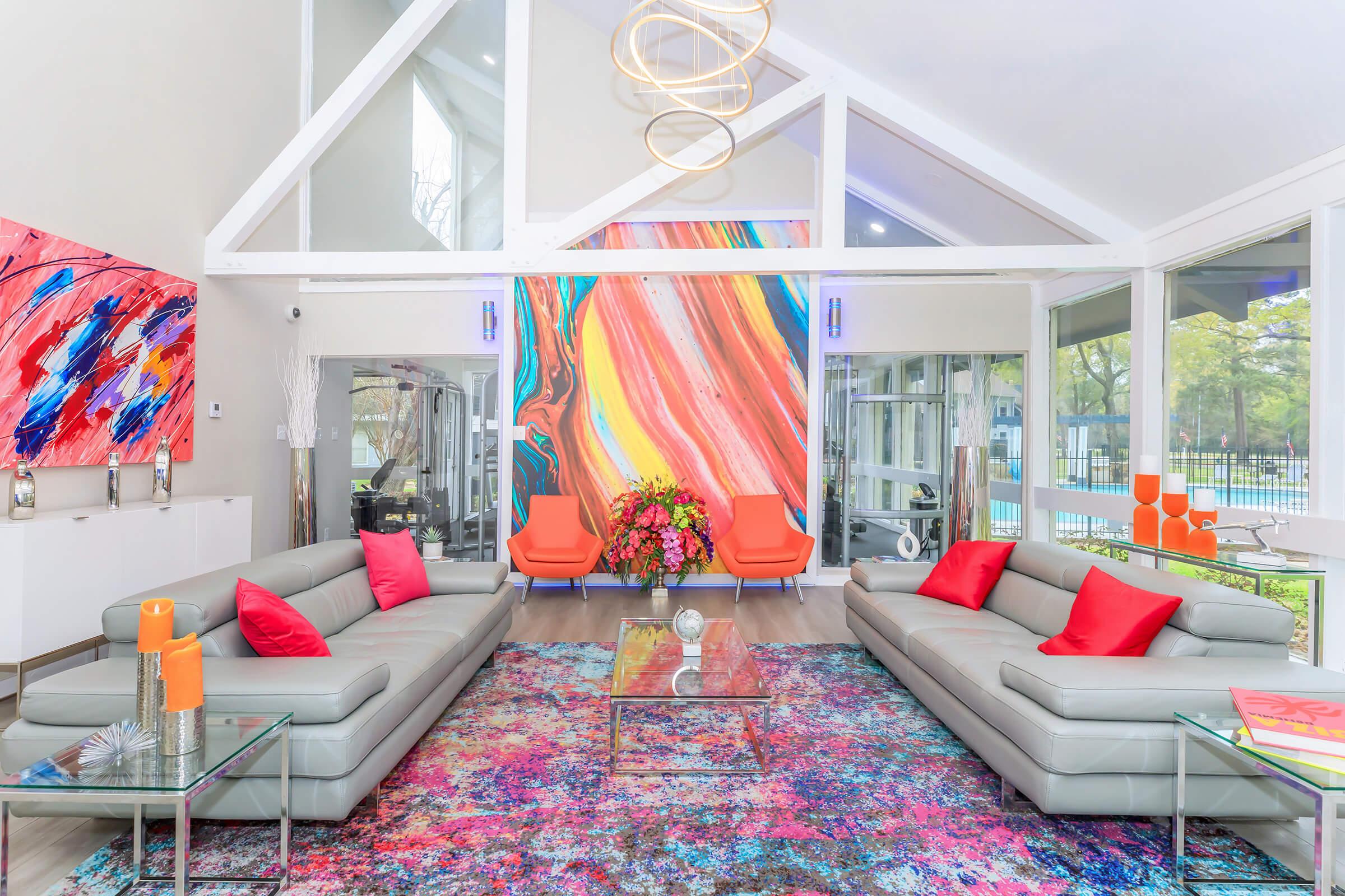 a living room filled with furniture and a large window