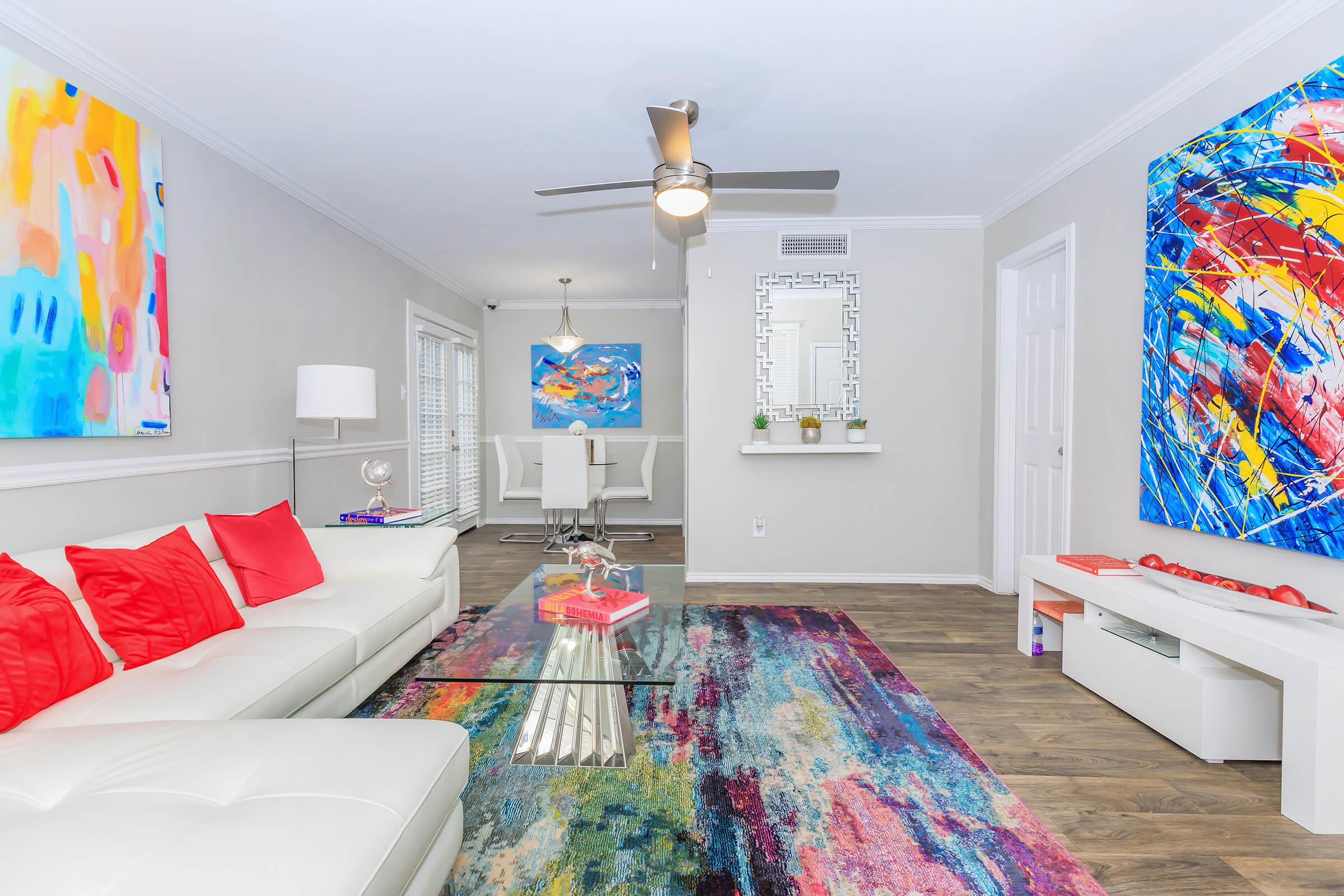 a colorful living room with a bed in a bedroom