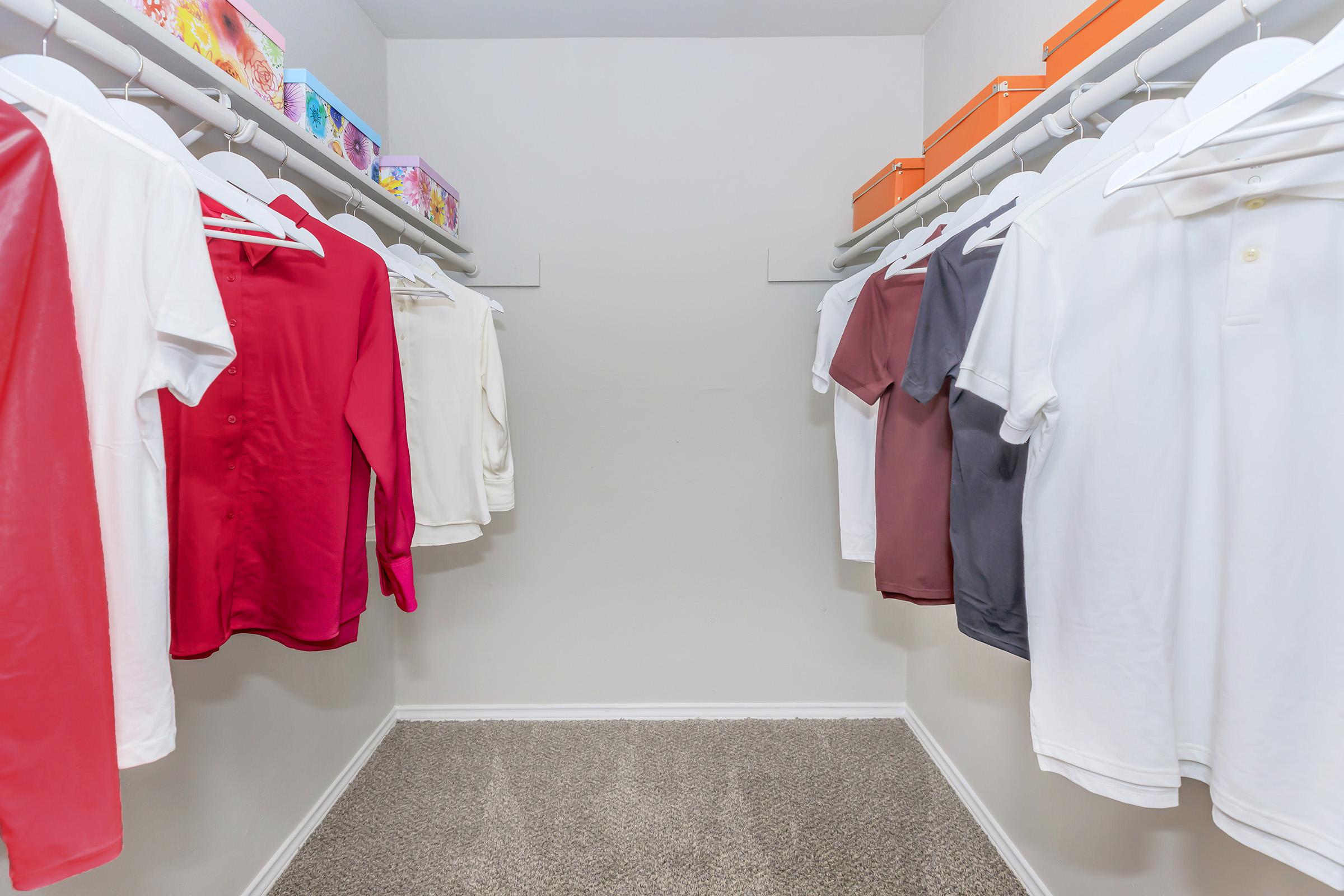 a bedroom with clothes on a bed