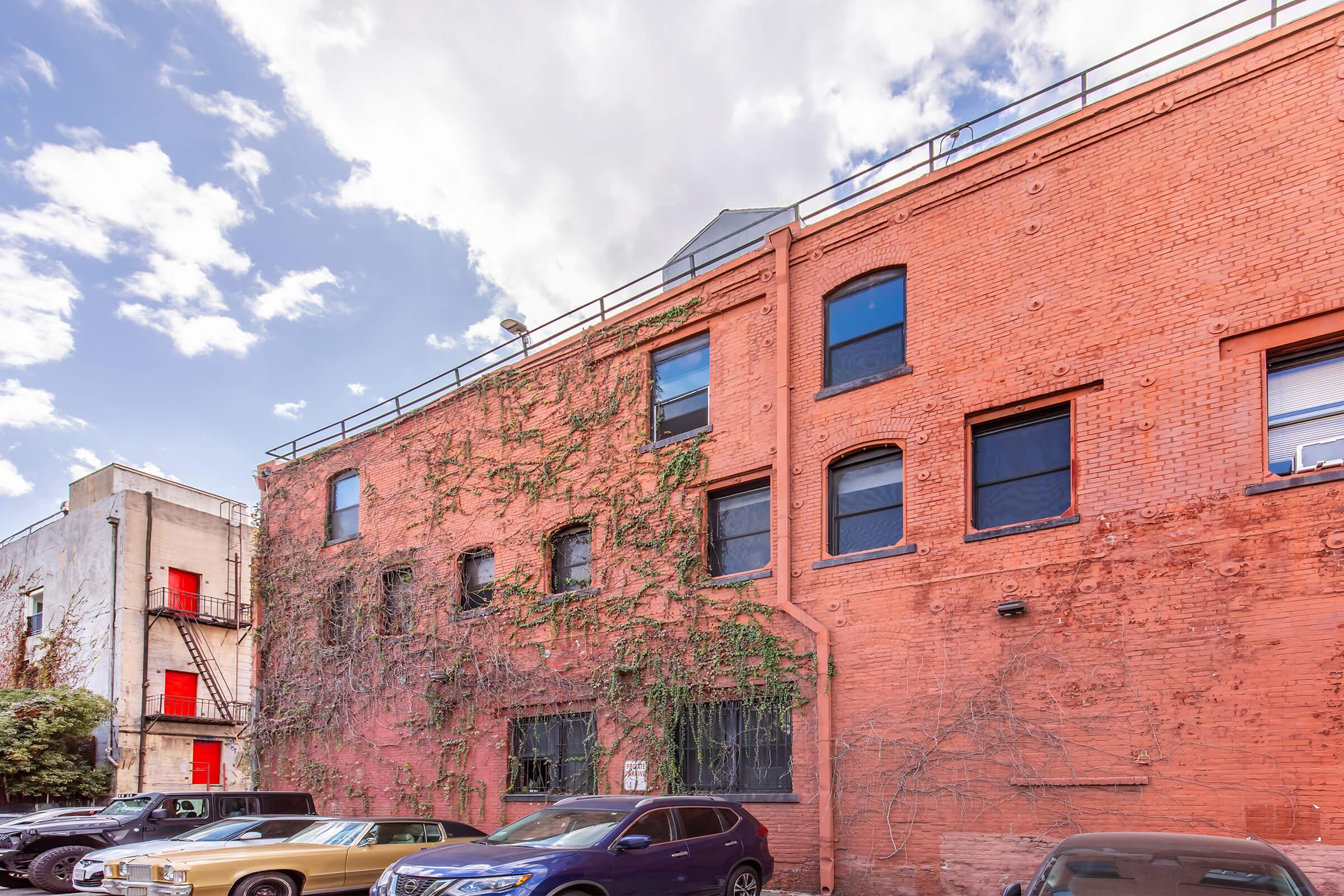 a car parked in front of a brick building