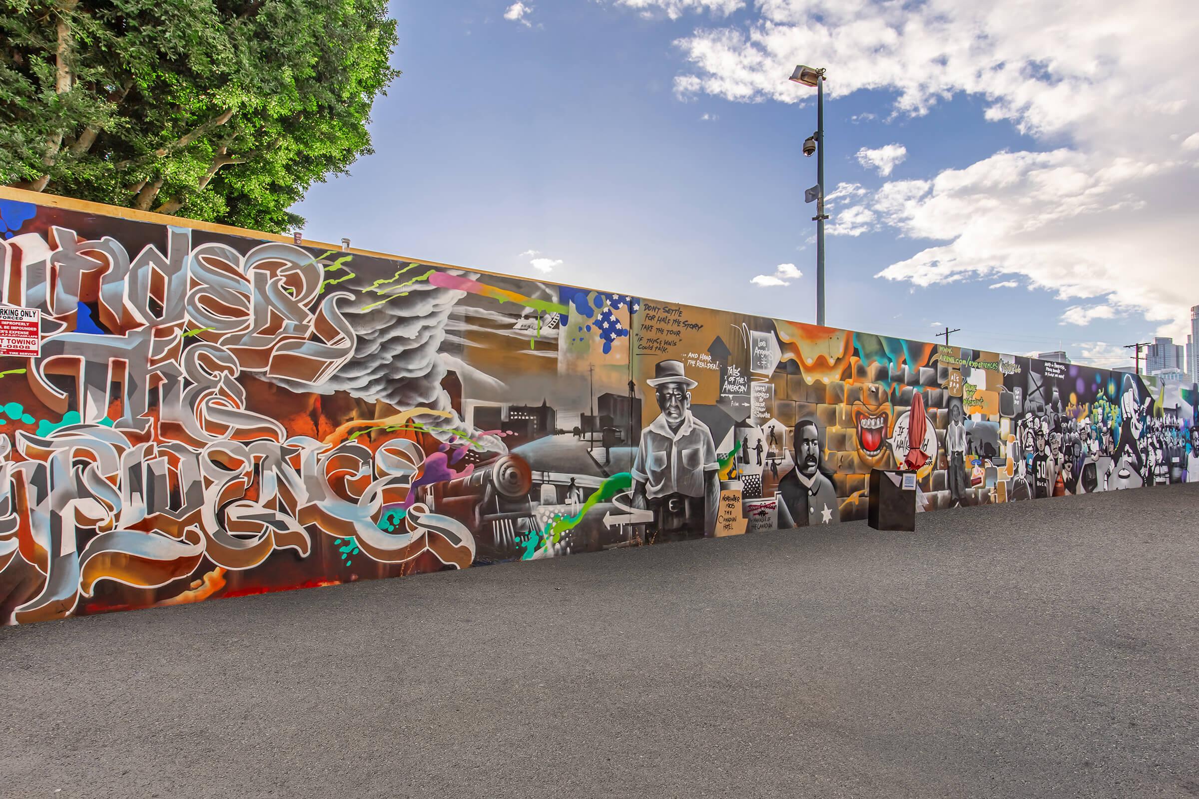 a group of people painted on the side of a road