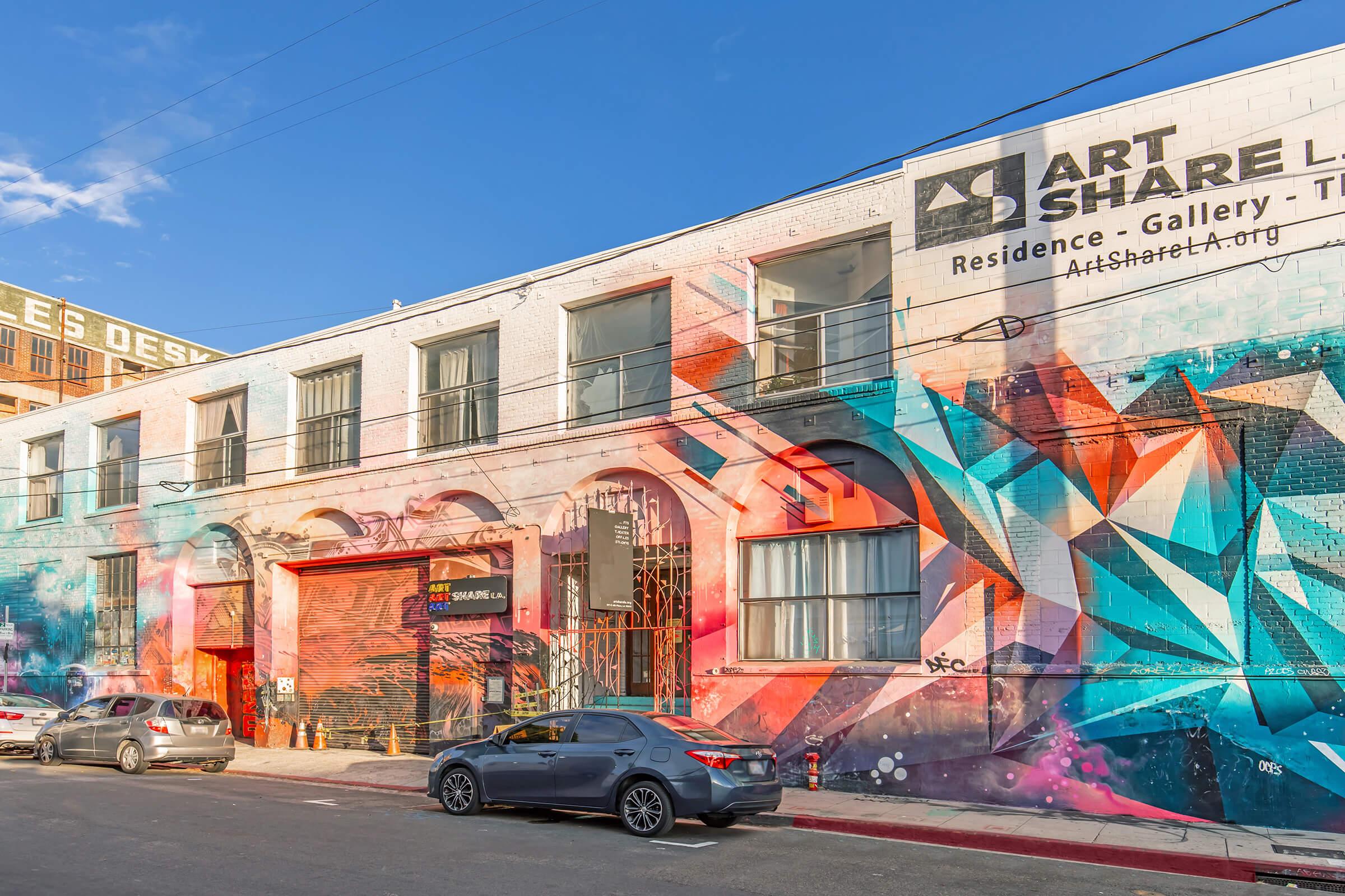 a building with graffiti on the side of a road