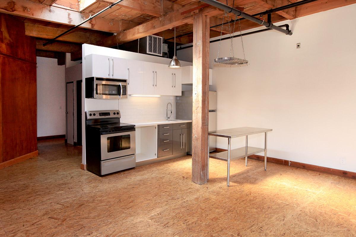 a kitchen area with a building in the background