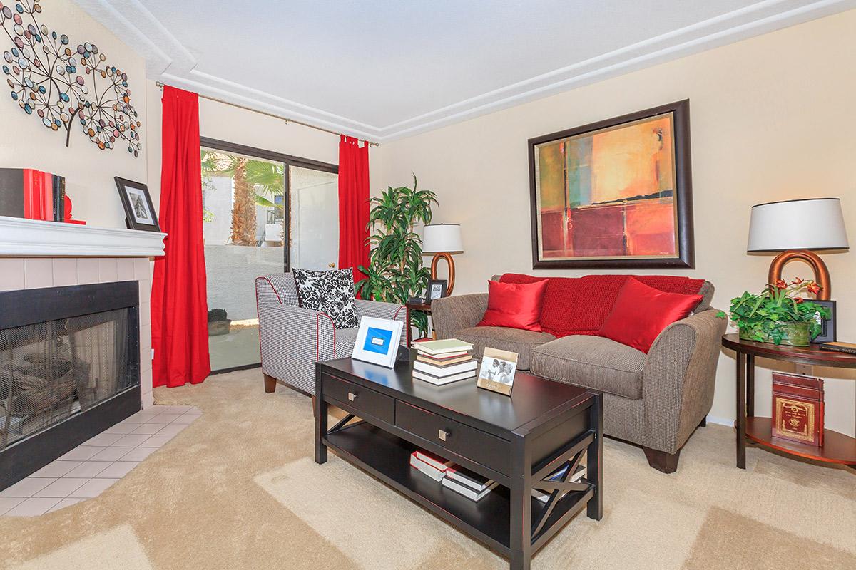 a living room filled with furniture and a flat screen tv