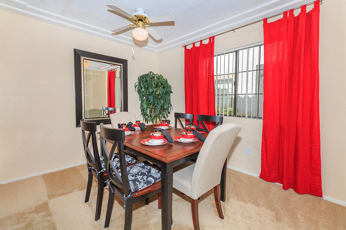 a living room filled with furniture and a red curtain