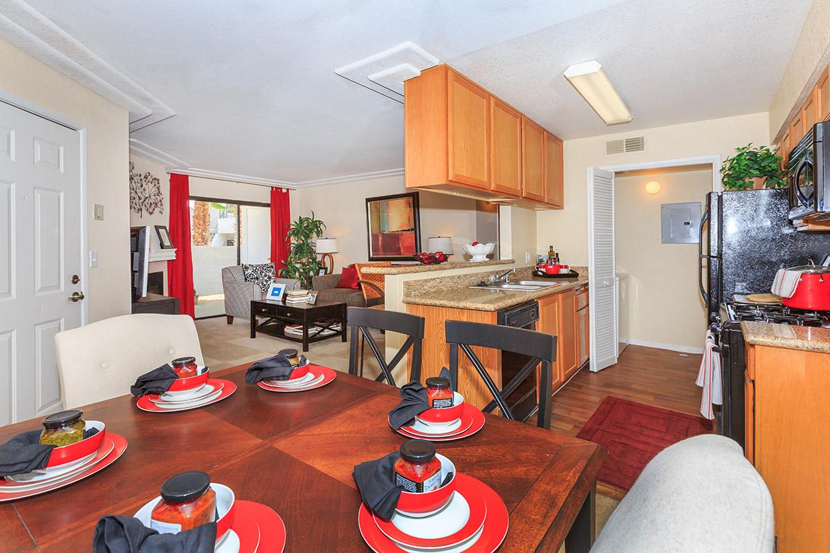 a living room filled with furniture and a red table