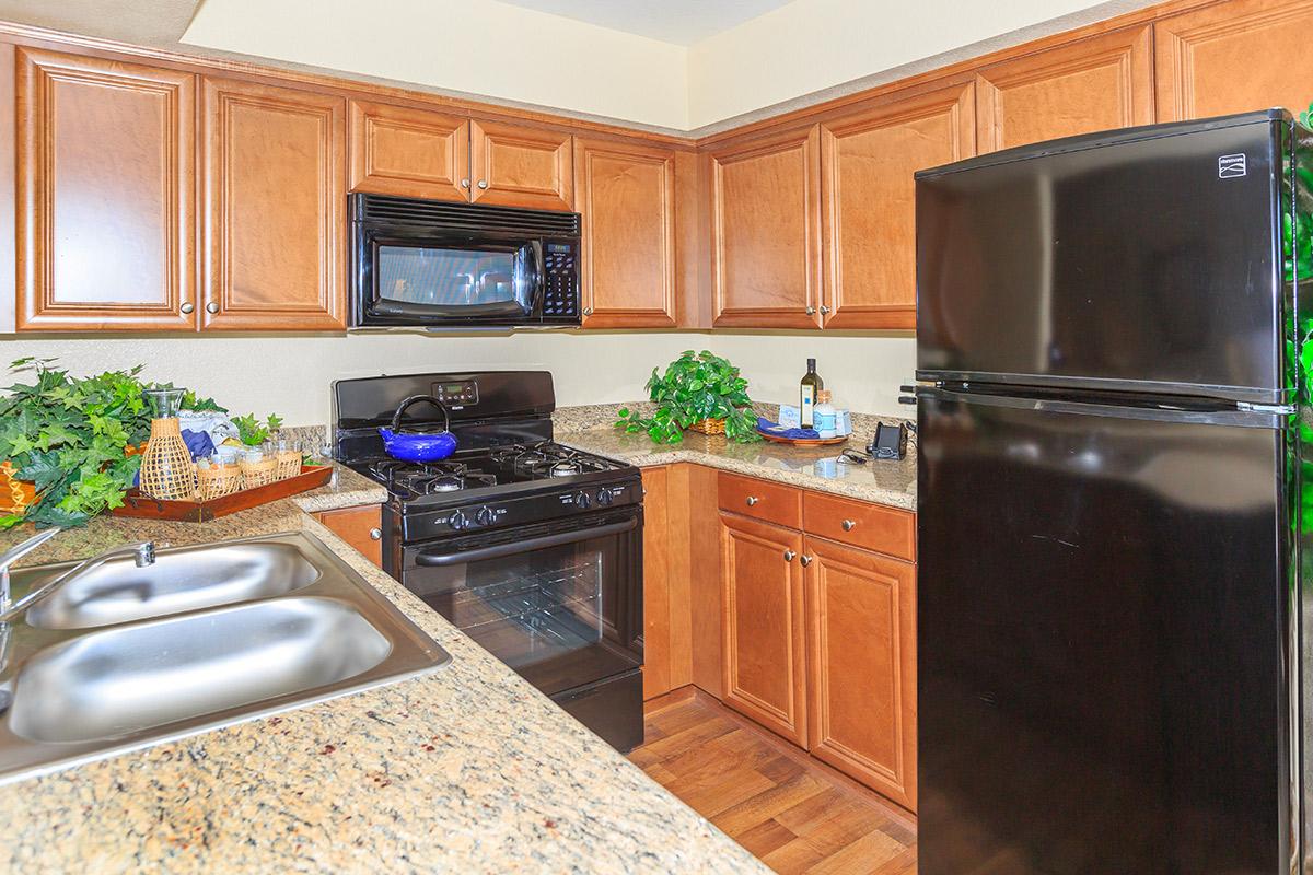 a kitchen with stainless steel appliances and wooden cabinets