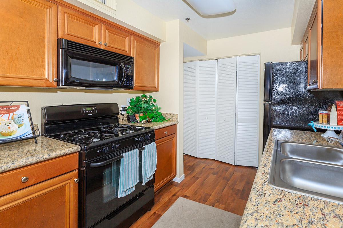 a stove top oven sitting inside of a kitchen