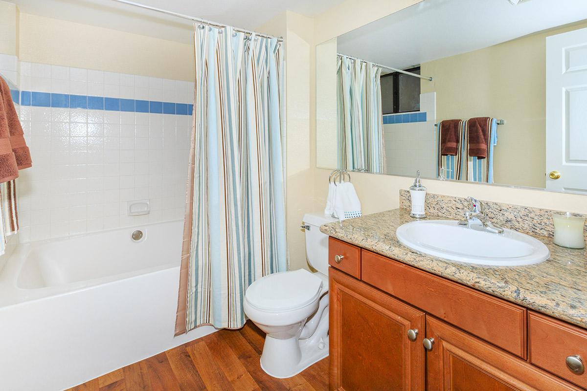 a large white tub next to a sink