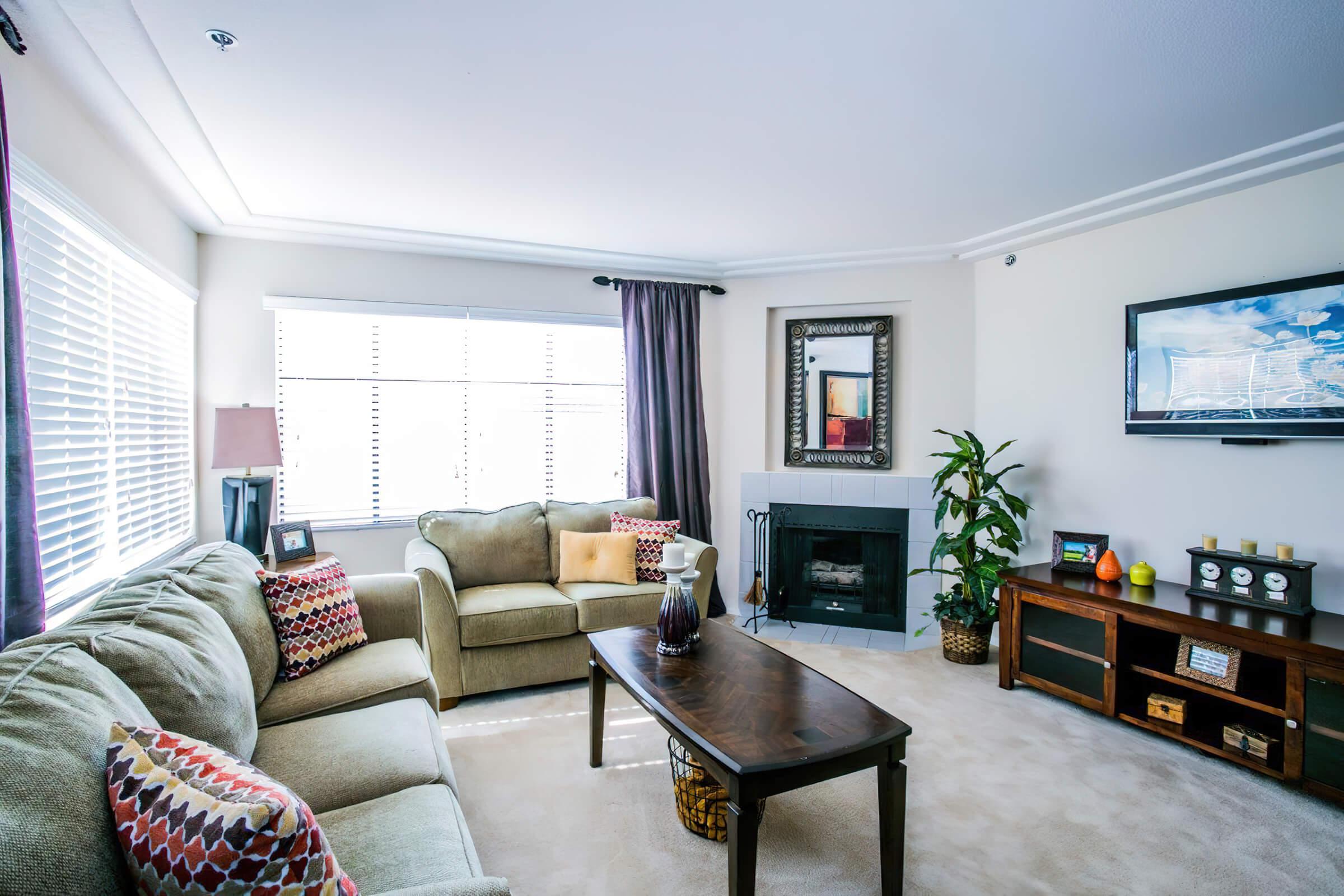 a living room filled with furniture and a large window