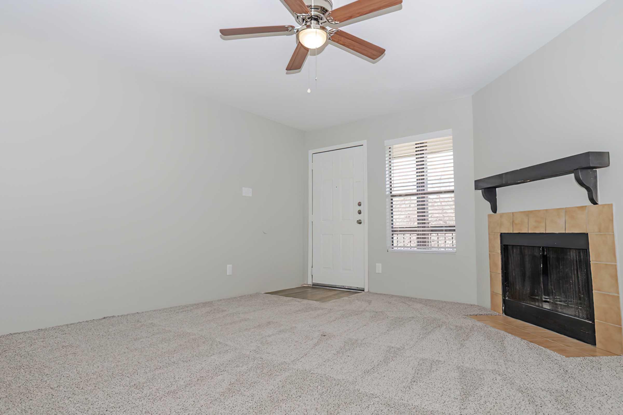 a living room with a bed and a fireplace