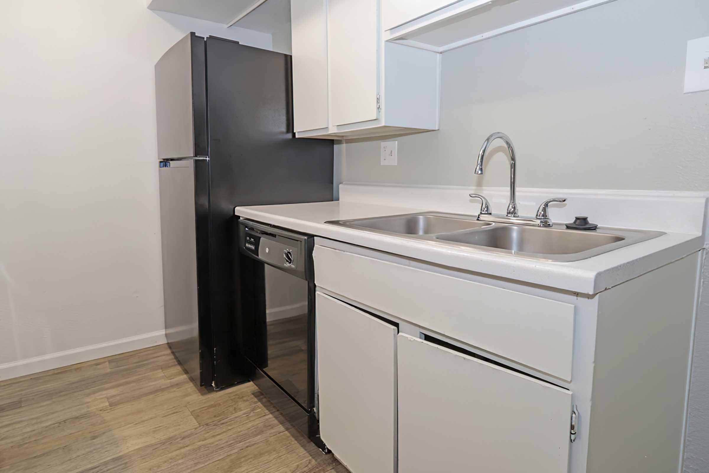 a kitchen with a sink and a mirror