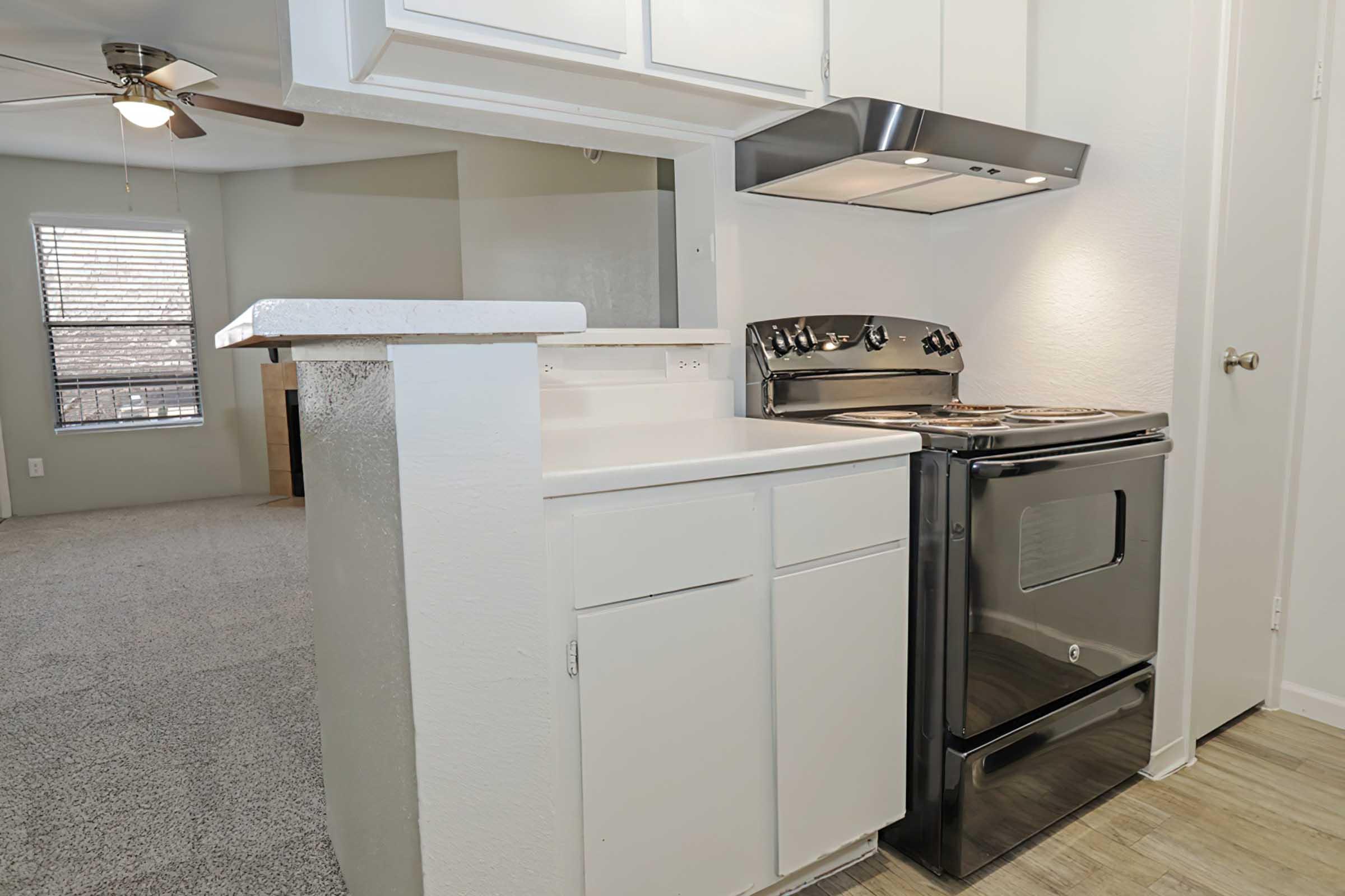 a kitchen with a stove top oven sitting inside of a refrigerator