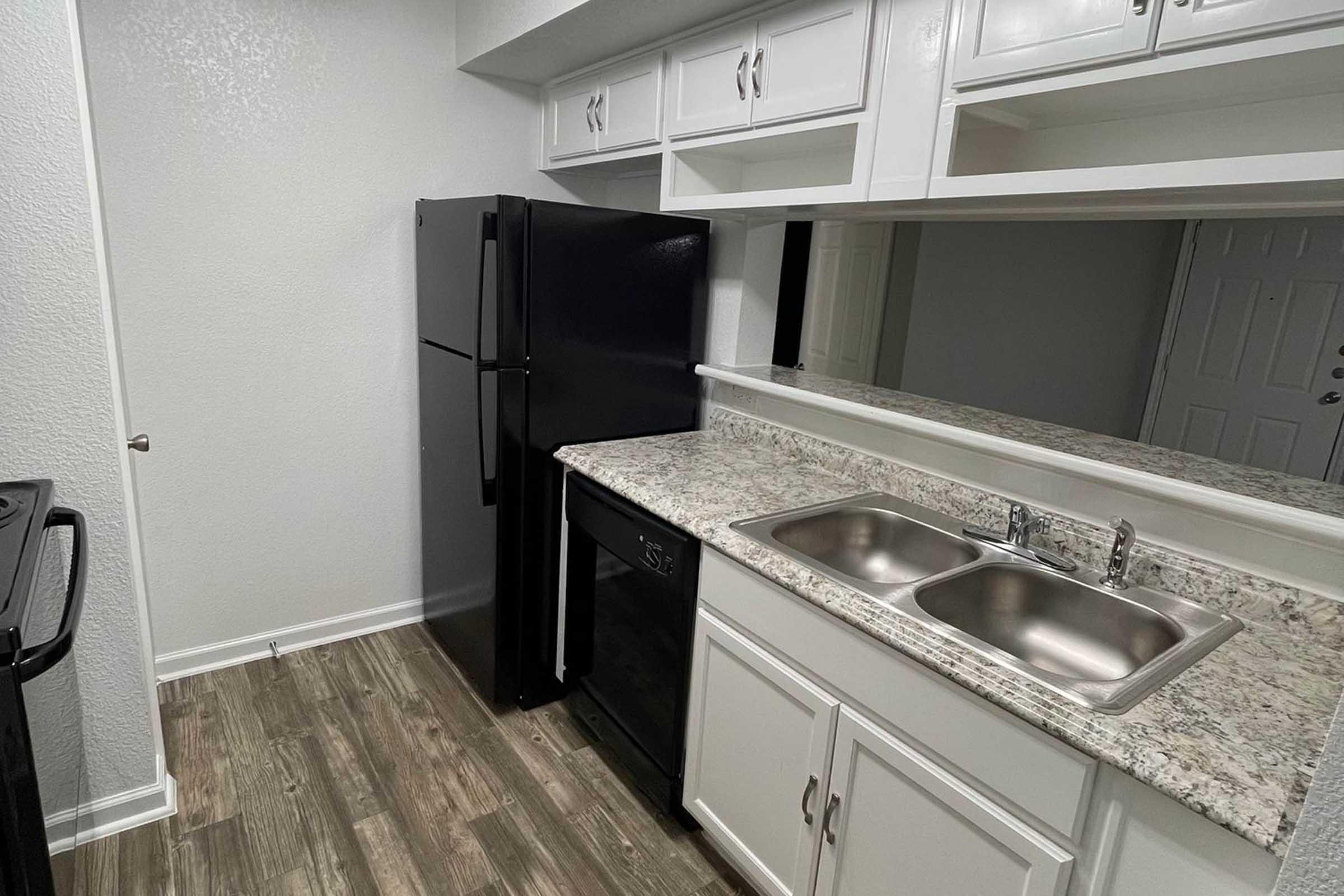 a kitchen with a sink and a microwave