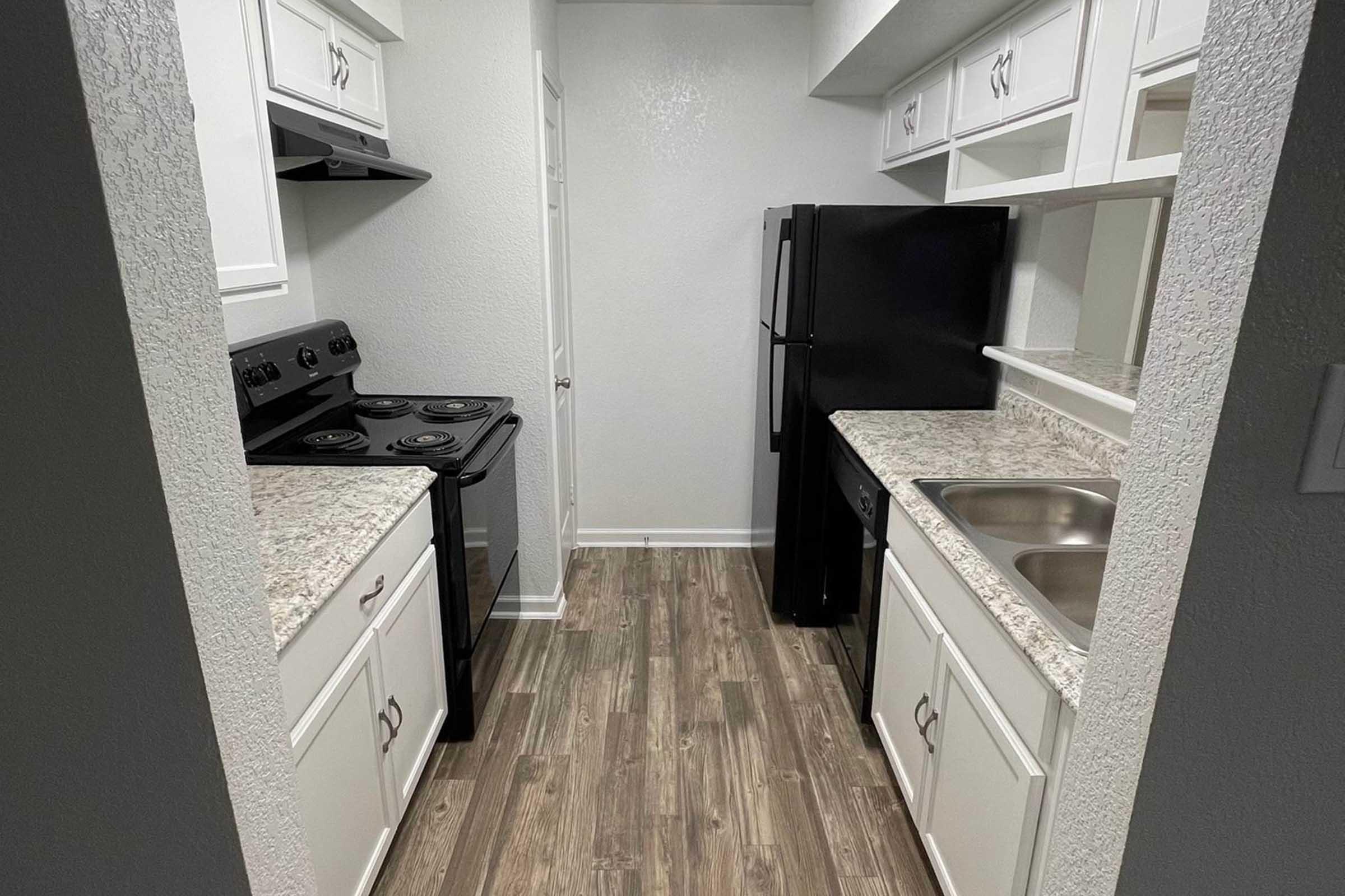 a kitchen with a sink and a refrigerator