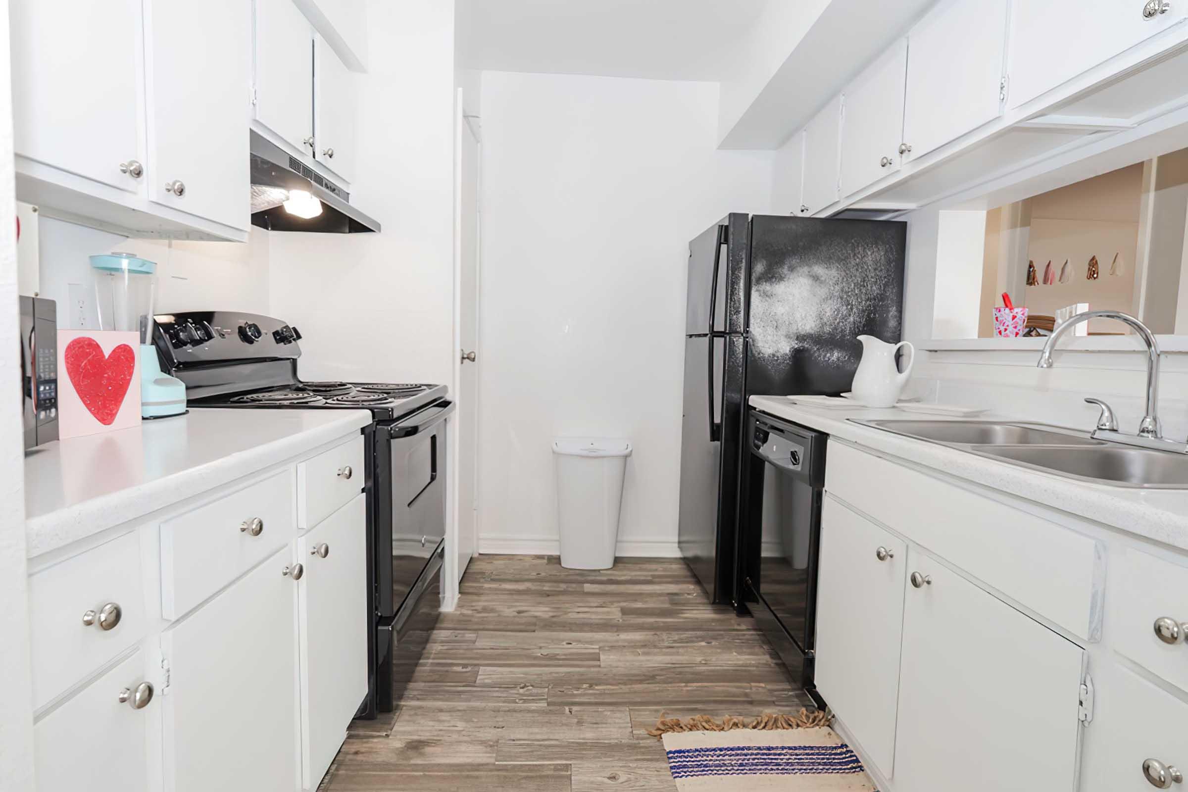 a kitchen with a sink and a refrigerator