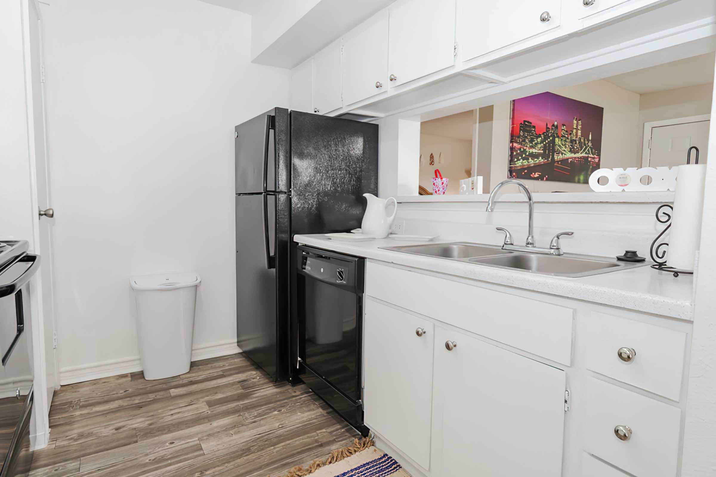 a kitchen with a sink and a mirror