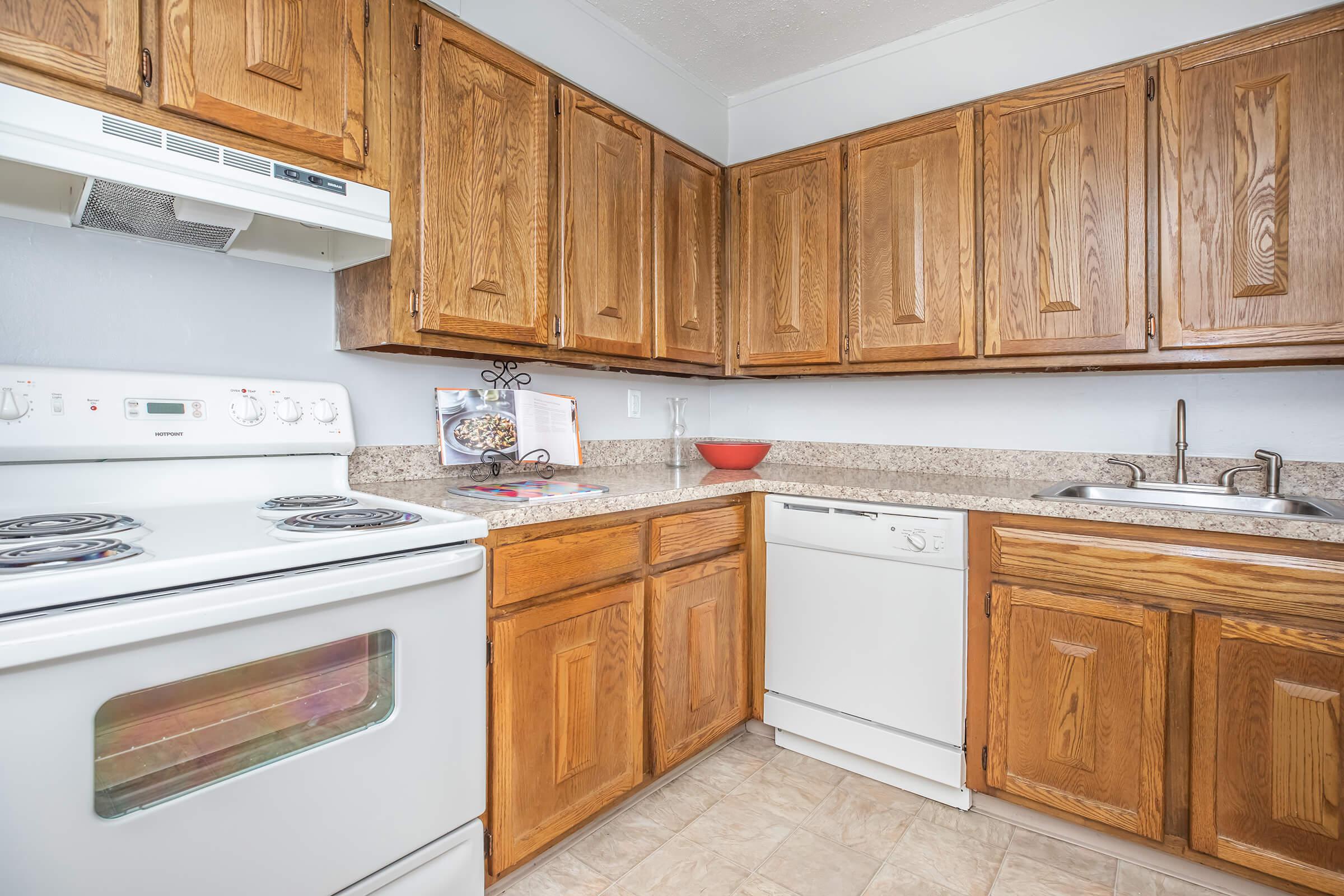 a kitchen with wooden cabinets and a microwave