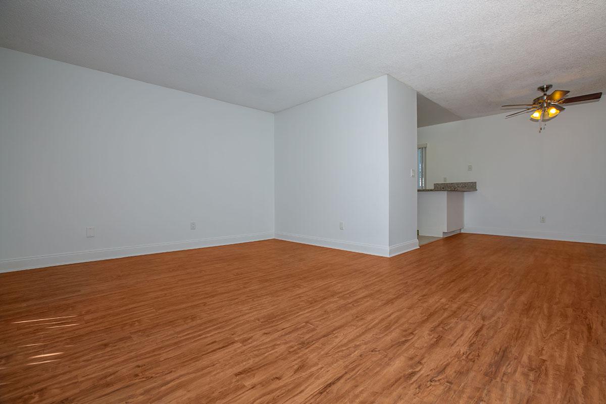 a bedroom with a wooden floor